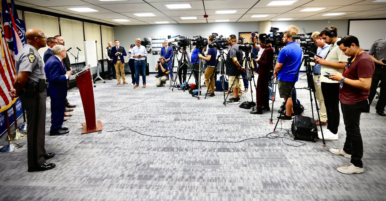 Ohio Gov. Mike DeWine spoke along with Ohio State Highway Patrol Col. Charles Jones (near left) and Ohio Department of Public Safety Director Andy Wilson, in announcing safety resources to Springfield City Schools and Superintendent Bob Hill (far left) in response to bomb threats. MARSHALL GORBY/STAFF