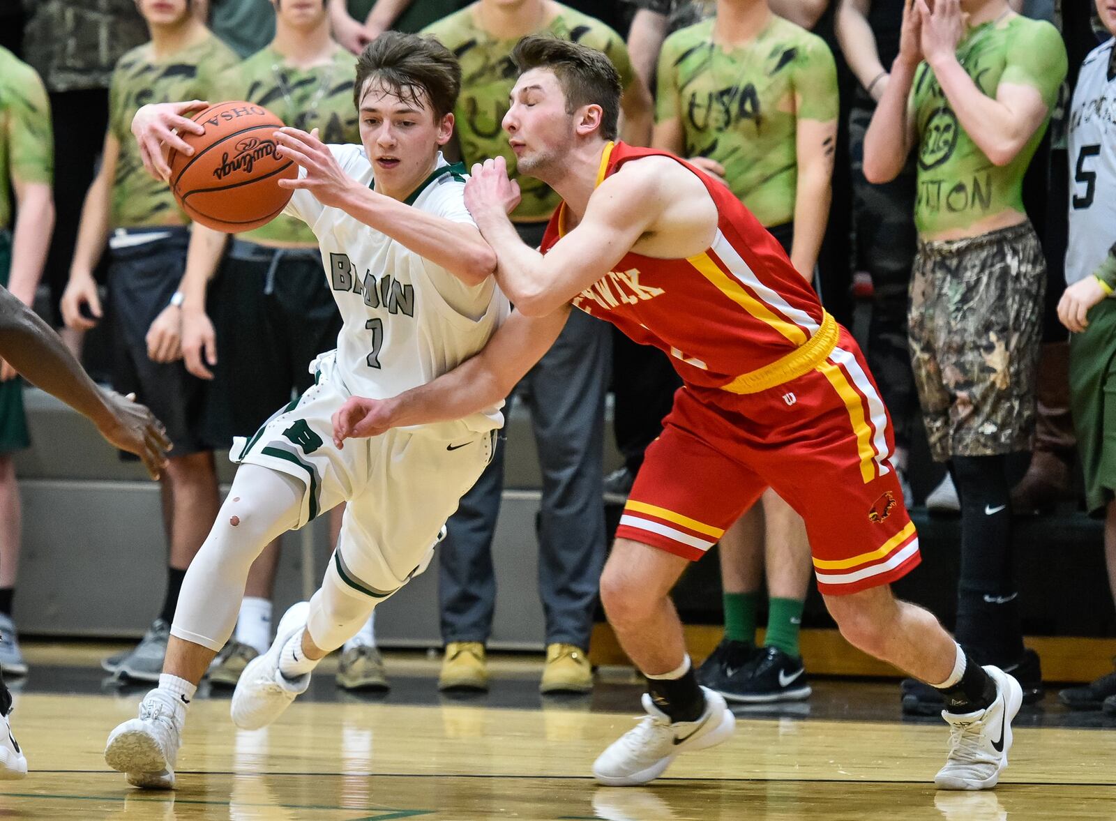 Badin’s Joseph Walsh (1) is closely defended by Fenwick’s Jared Morris on Friday night at Mulcahey Gym in Hamilton. NICK GRAHAM/STAFF