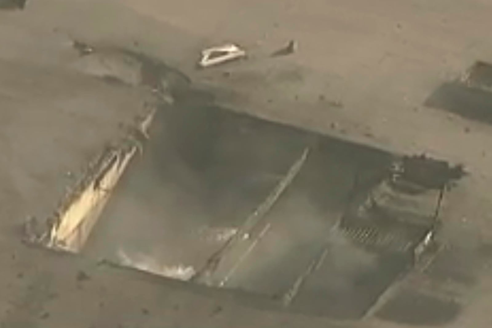 In this image taken from video, shows a gaping hole in a commercial building after a small plane crashed through the rooftop in Fullerton, Calif. on Thursday, Jan. 2, 2025. (KABC-7 via AP)