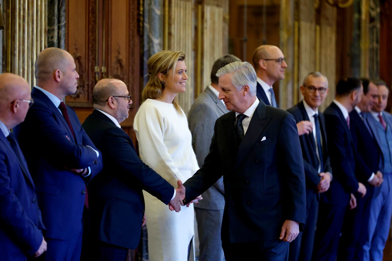 Belgium's King Philippe, center, shakes hands with Belgium's new Interior Minister Bernard Quintin during a swearing in ceremony for the new government at the Royal Palace in Brussels, Monday, Feb. 3, 2025. (AP Photo/Omar Havana)