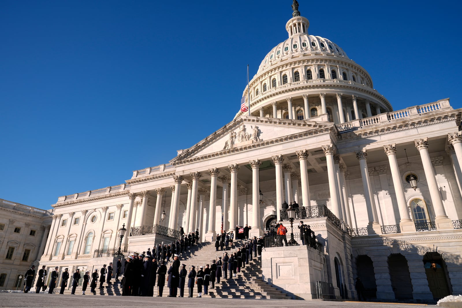 A joint services body bearer team carries the flag-draped casket of former President Jimmy Carter from the U.S. Capitol in Washington, Thursday, Jan. 9, 2025, to head to Washington National Cathedral for a State Funeral. (AP Photo/Susan Walsh, Pool)