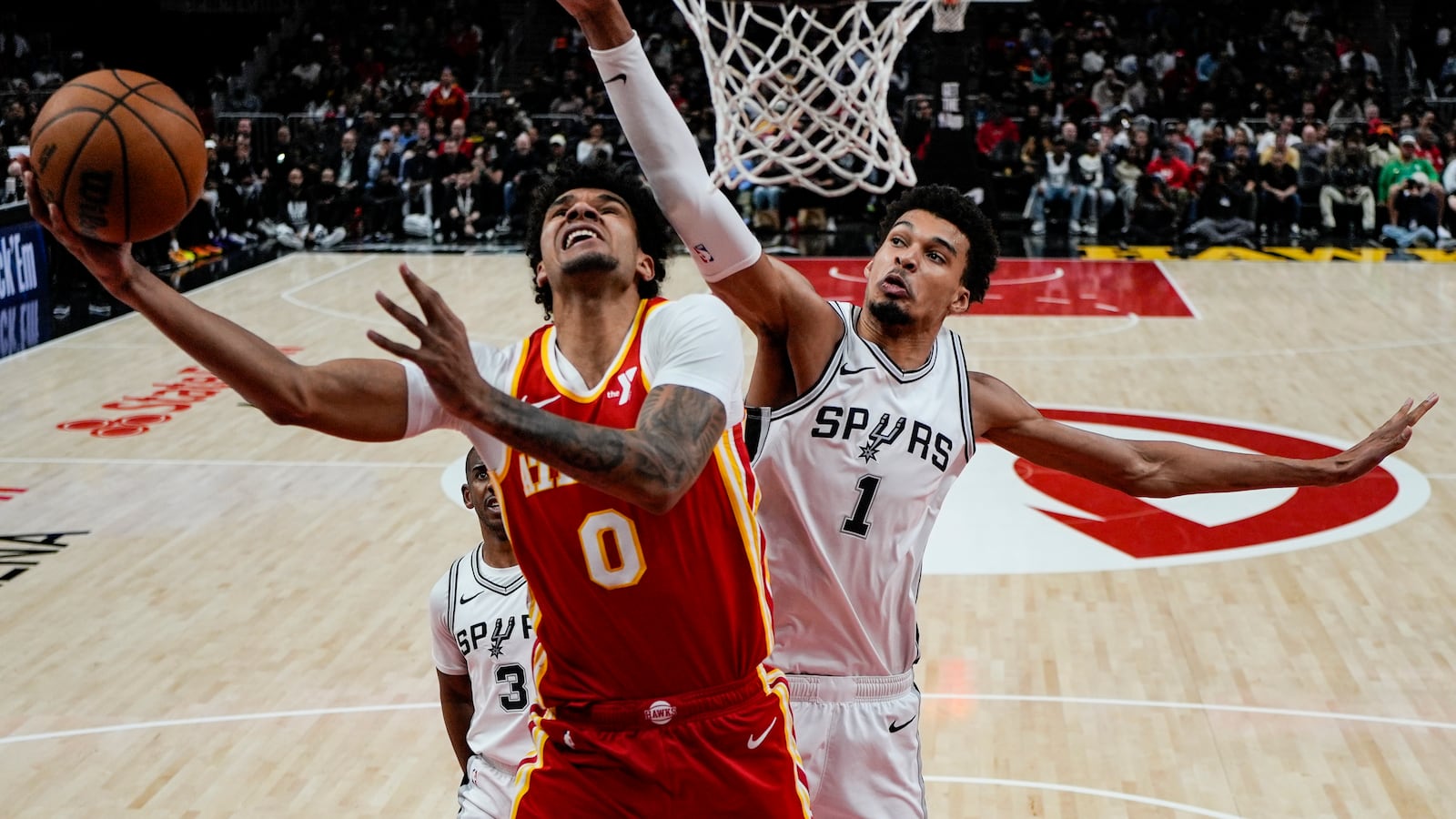 =h0= shoots against San Antonio Spurs center Victor Wembanyama (1) during the second half of an NBA basketball game, Wednesday, Feb. 5, 2025, in Atlanta. (AP Photo/Mike Stewart)