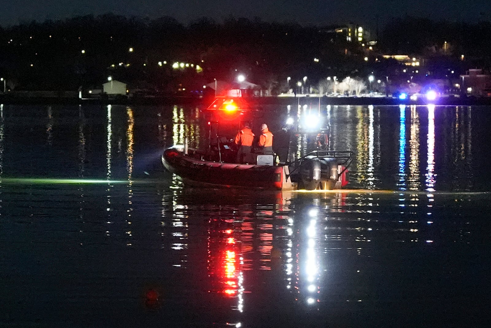 A boat works the scene near Ronald Reagan Washington National Airport, Thursday, Jan. 30, 2025, in Arlington, Va. (AP Photo/Alex Brandon)