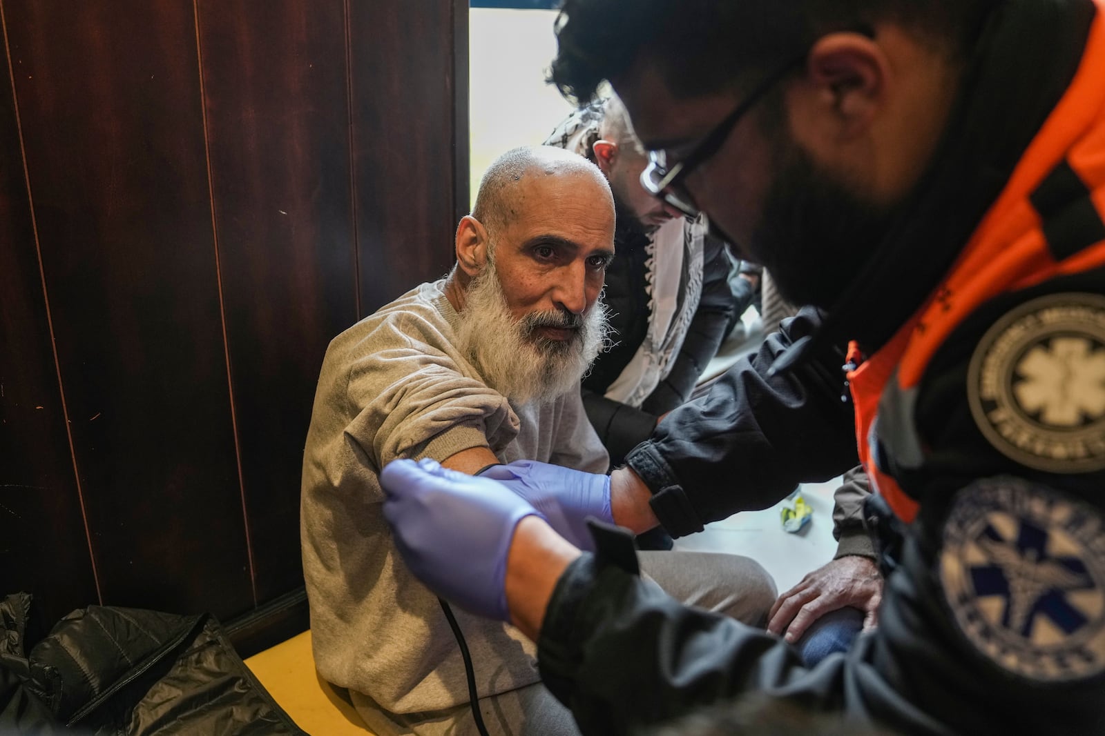 A Palestinian prisoner is checked by medical personnel after being released from Israeli prison following a ceasefire agreement between Israel and Hamas, in the West Bank city of Ramallah, Saturday Feb. 8, 2025. (AP Photo/Mahmoud Illean)