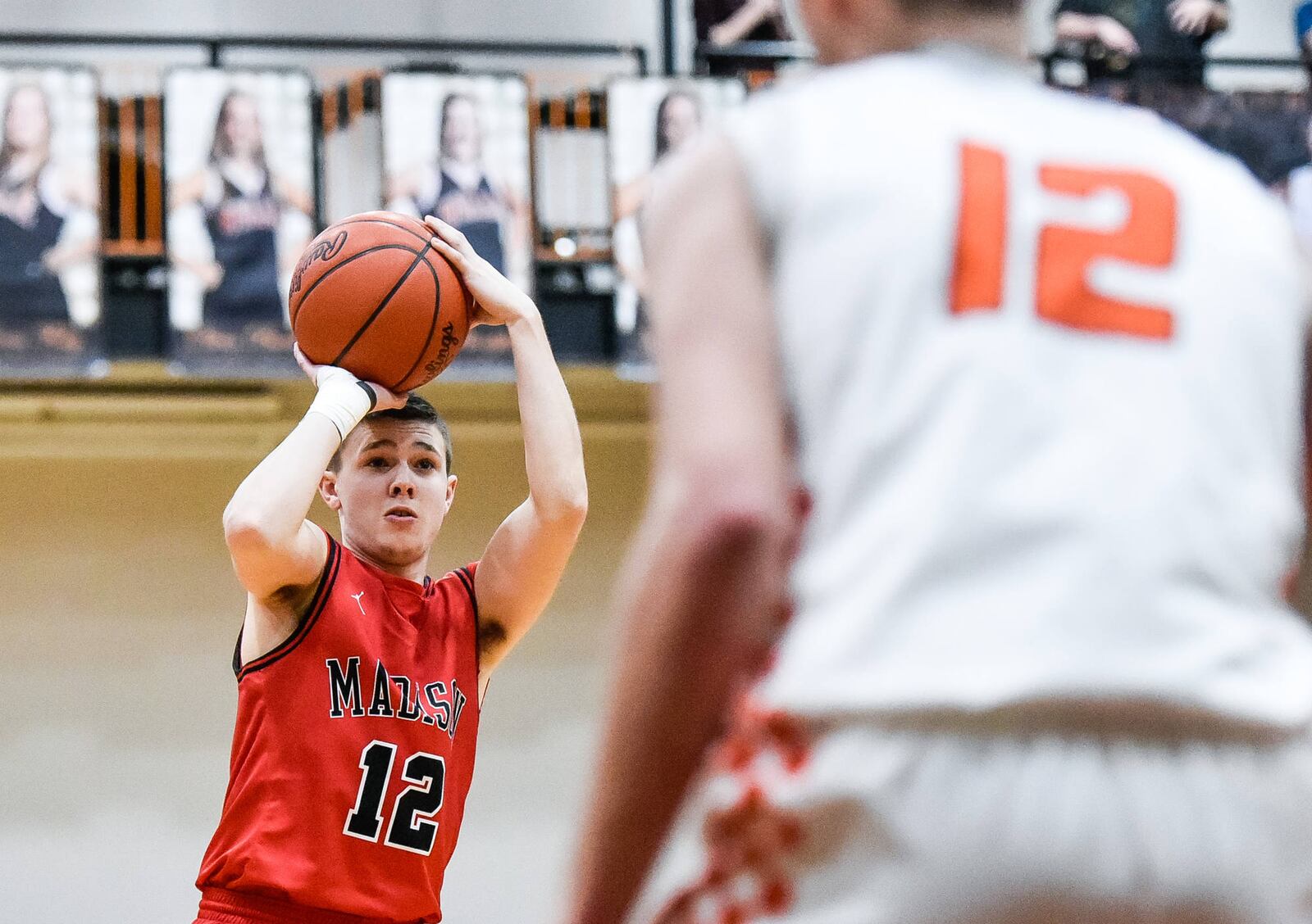 Madison’s Cameron Morgan prepares to shoot as Waynesville’s John Cole watches during Friday night’s game in Waynesville. The host Spartans won 59-39. NICK GRAHAM/STAFF