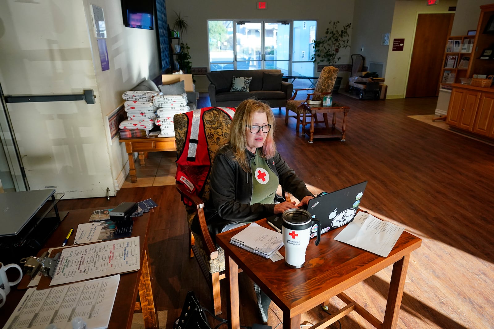 Kimberly Culver of the Hill Country Red Cross works the evacuation center for the 7 Crabapple Fire evacuee's at Zion Lutheran Church in Fredericksburg, Texas, Sunday, March 16, 2025. (Robin Jerstad/The San Antonio Express-News via AP)