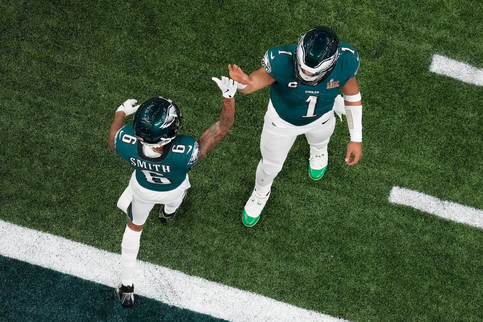 Philadelphia Eagles quarterback Jalen Hurts (1) celebrates with wide receiver DeVonta Smith (6) after throwing a touchdown pass to wide receiver A.J. Brown during the first half of the NFL Super Bowl 59 football game against the Kansas City Chiefs, Sunday, Feb. 9, 2025, in New Orleans. (AP Photo/David J. Phillip)