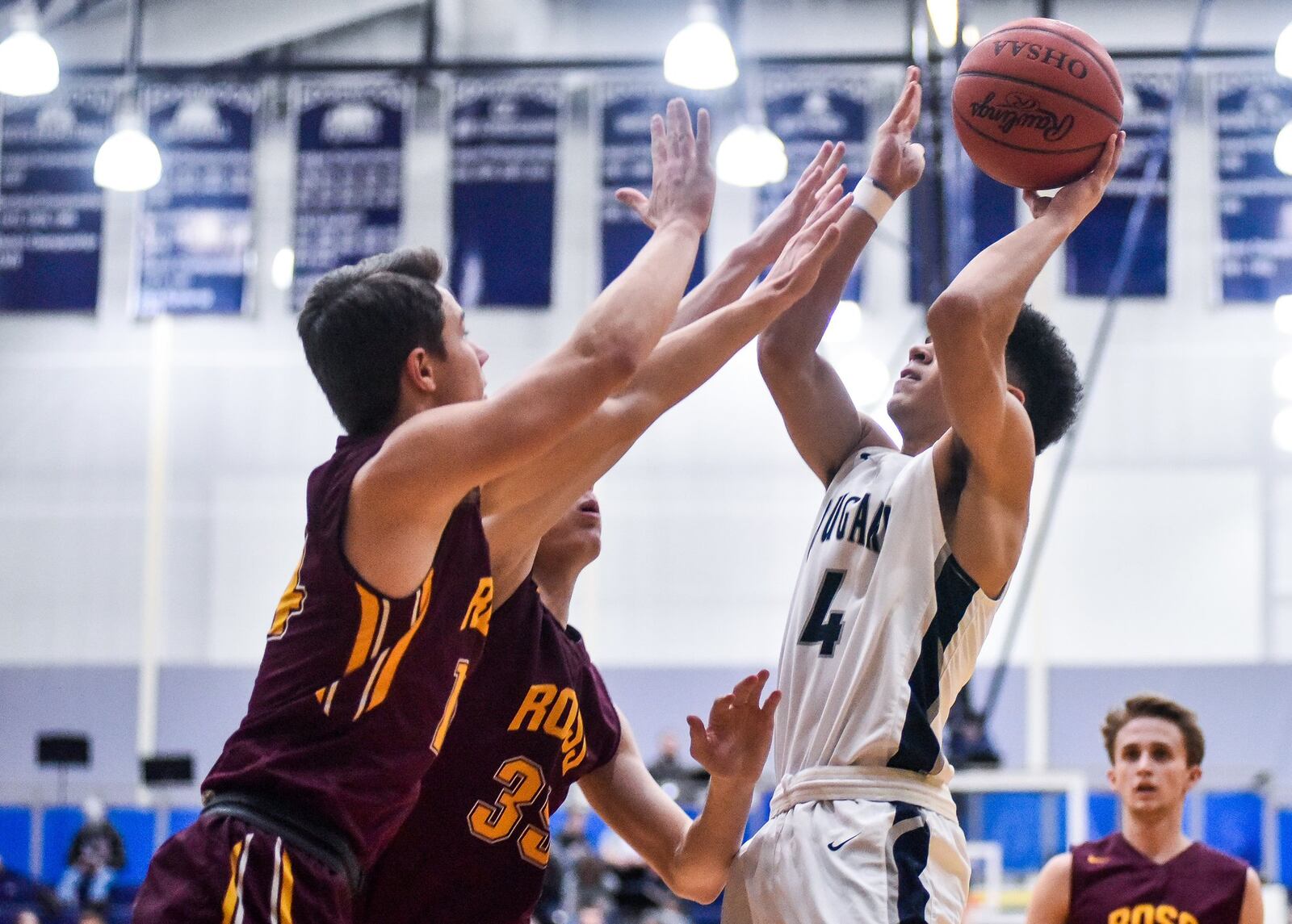 Edgewood’s Aaron Frazier puts up a shot as Cooper Shields and Cody Geers of Ross provide tight defense during Friday night’s game at Edgewood. Ross won 49-34. NICK GRAHAM/STAFF