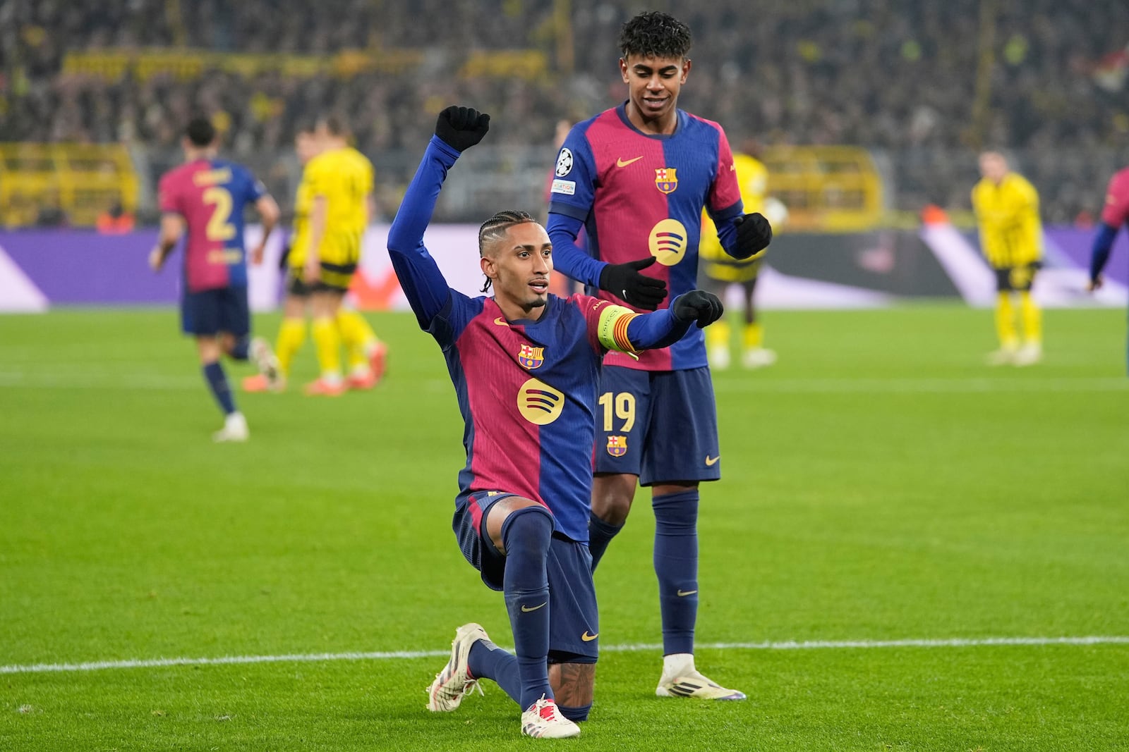 Barcelona's Raphinha celebrates the opening goal during the Champions League opening phase soccer match between Borussia Dortmund and FC Barcelona at the Signal-Iduna Park in Dortmund, Germany, Wednesday Dec. 11, 2024. (AP Photo/Martin Meissner)