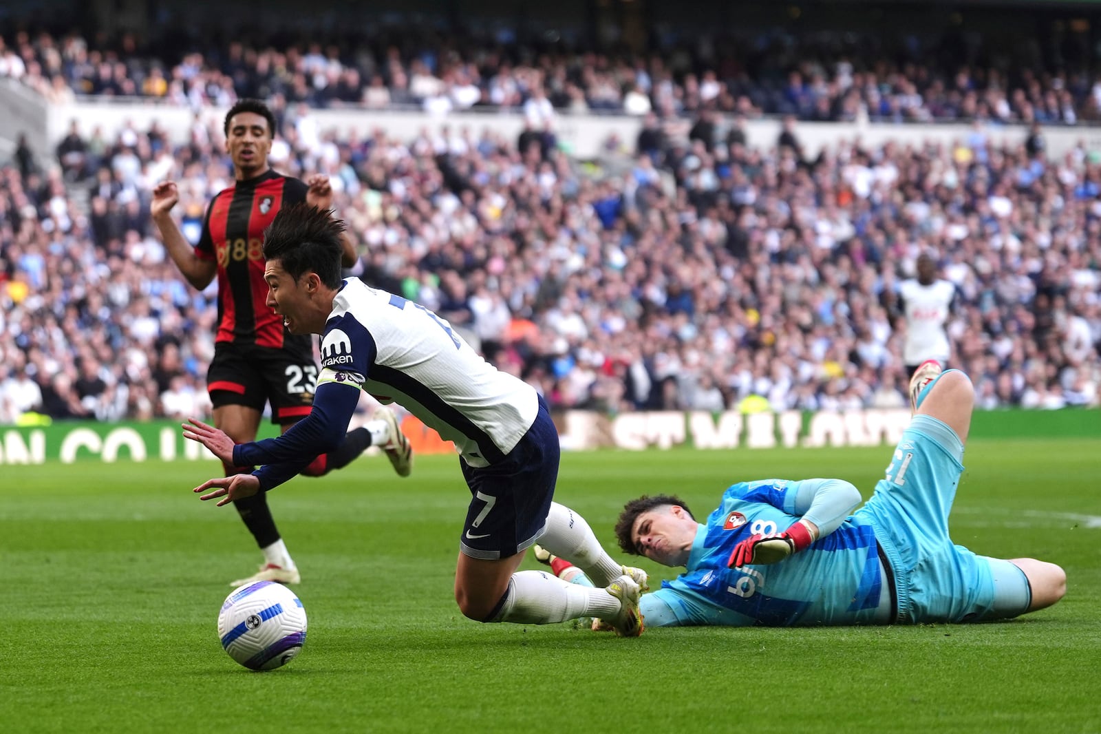 Bournemouth goalkeeper Kepa Arrizabalaga, right, challenges Tottenham Hotspur's Son Heung-Min which results in a penalty kick for Tottenham Hotspur, during the English Premier League soccer match between Tottenham Hotspur and Bournemouth, at the Tottenham Hotspur Stadium, in London, Sunday March 9, 2025. (Bradley Collyer/PA via AP)