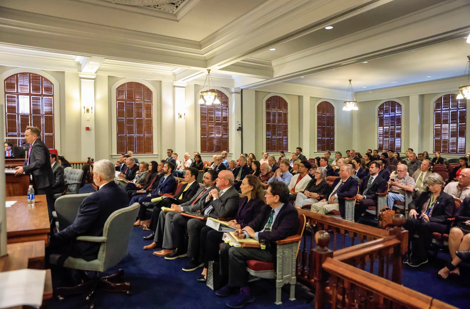 Audience members listen as attorney Adam Romney speaks during a Hawaii Supreme Court hearing in Honolulu, Thursday, Feb. 6, 2025, regarding settlements related to the 2023 Lahaina wildfires. (Jamm Aquino/Honolulu Star-Advertiser via AP, Pool)