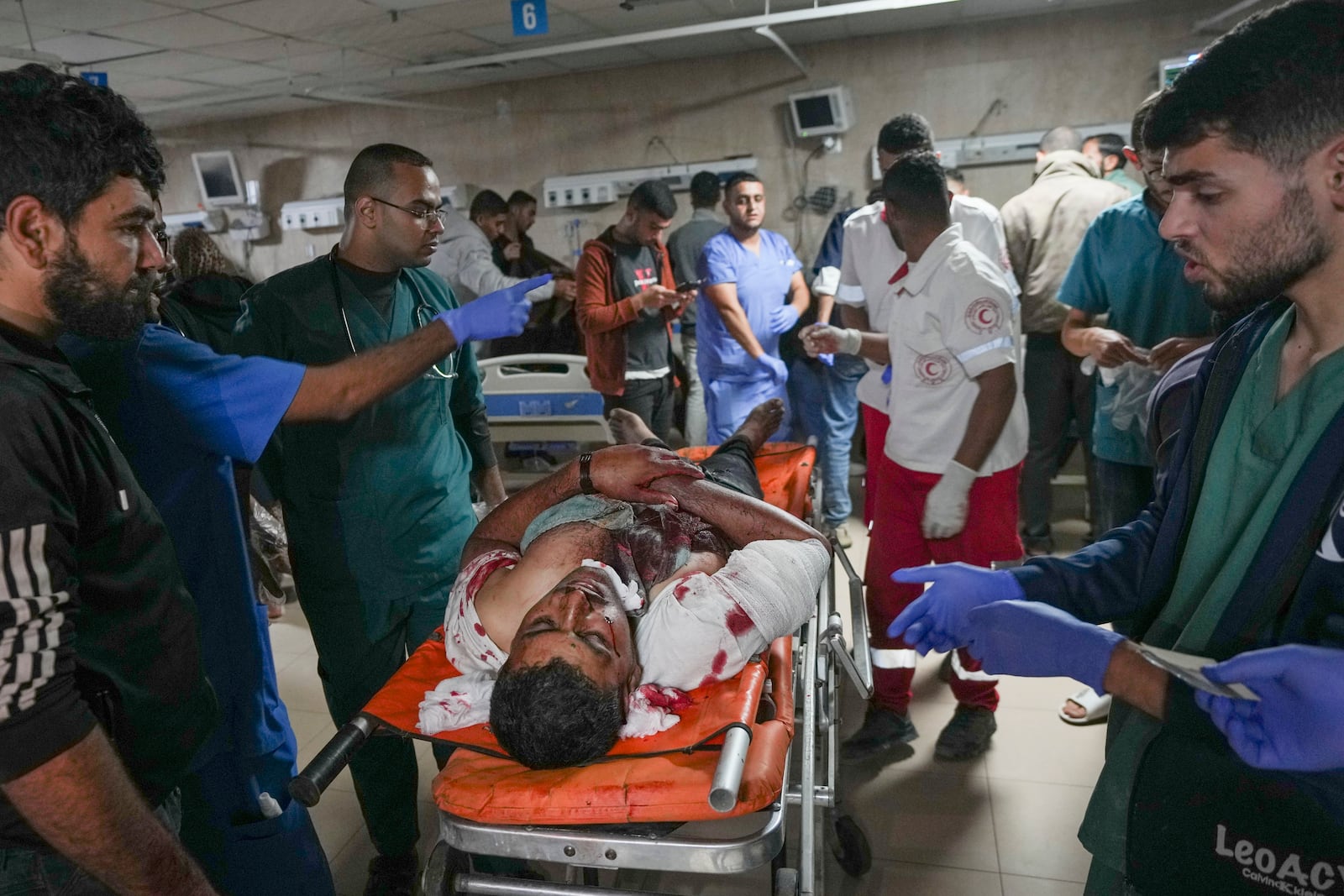 Medics carry a wounded man after an Israeli army strike at a hospital in Deir al-Balah, Gaza, late Saturday Nov. 16, 2024. Israeli strikes in the Gaza Strip overnight killed 12 people, Palestinian medical officials said Sunday(AP Photo/Abdel Kareem Hana)