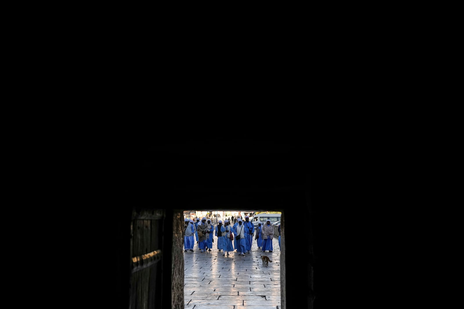 Nigerian worshippers walk along the Church of the Nativity, traditionally believed to be the birthplace of Jesus, on Christmas Eve, in the West Bank city of Bethlehem, Tuesday, Dec. 24, 2024. (AP Photo/Matias Delacroix)