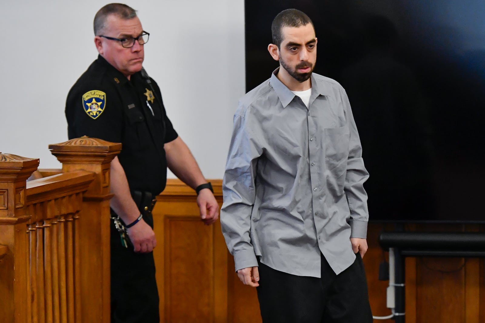 Hadi Matar, right, charged with severely injuring author Salman Rushdie in a 2022 knife attack, walks in to Chautauqua County court in Mayville, N.Y., Thursday, Feb. 20, 2025. (AP Photo/Adrian Kraus)