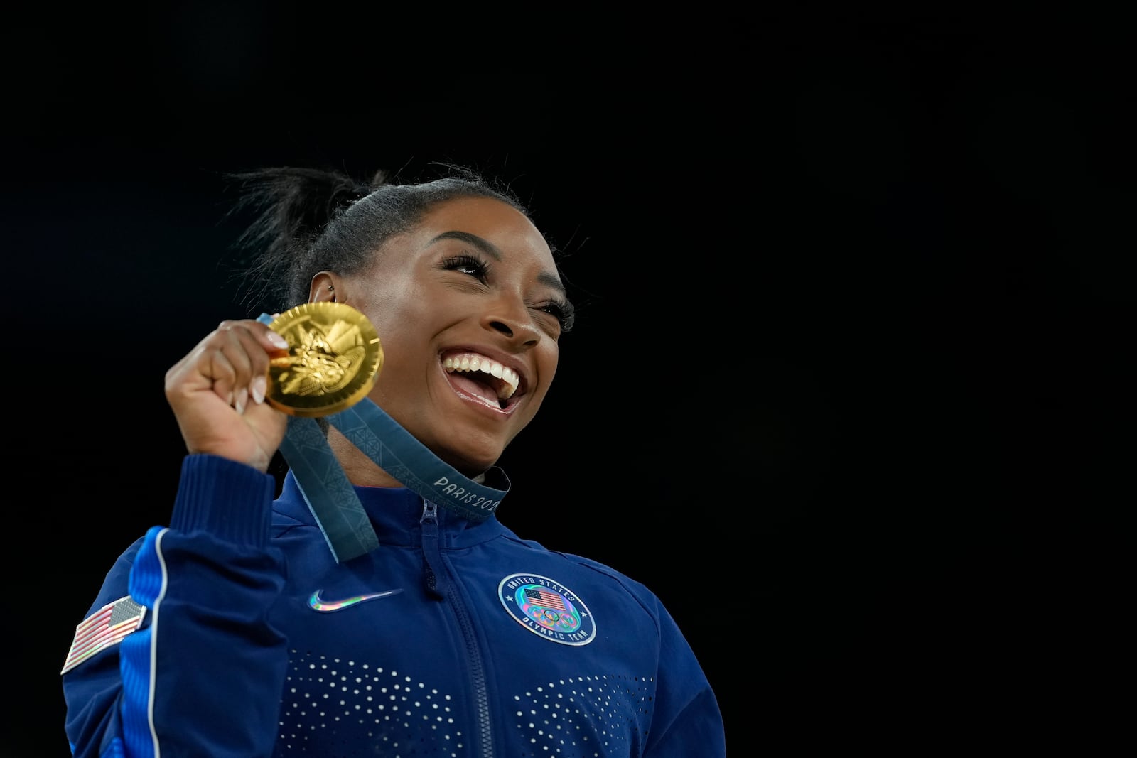 FILE -0 Simone Biles, of the United States, celebrates after winning the gold medal at the medal ceremony during the women's artistic gymnastics individual vault finals at Bercy Arena at the 2024 Summer Olympics, Saturday, Aug. 3, 2024, in Paris, France. (AP Photo/Francisco Seco, File)