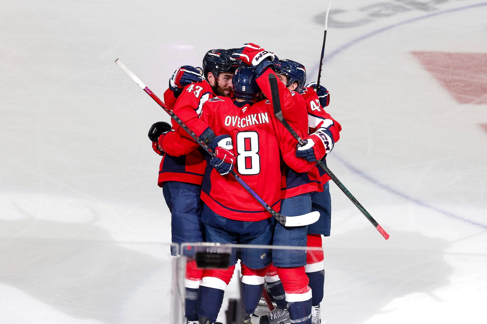 Washington Capitals left wing Alex Ovechkin (8) celebrates his 886th goal with teammates during the third period of an NHL hockey game against the Seattle Kraken, Sunday, March 9, 2025, in Washington. (AP Photo/Terrance Williams)