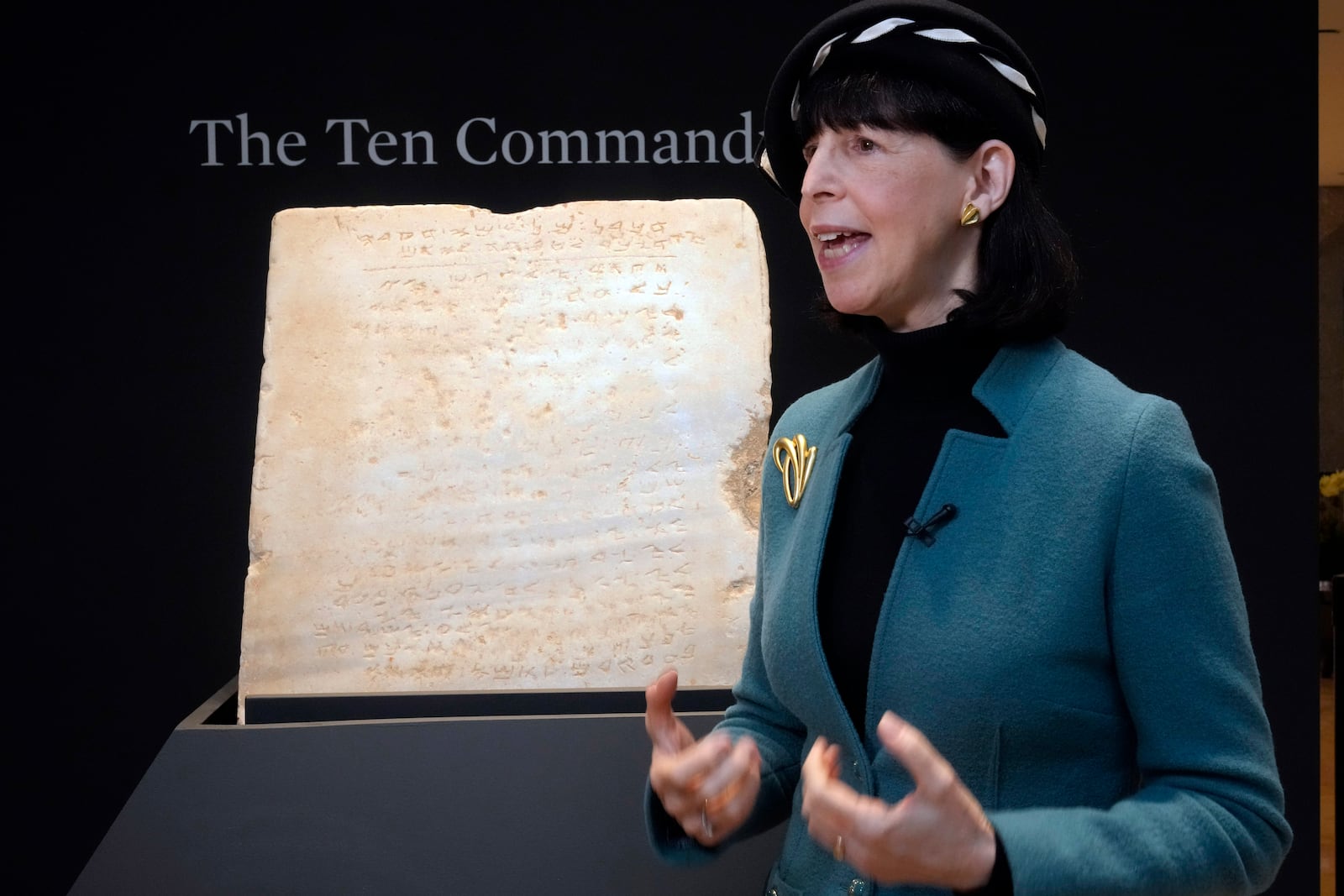 Sharon Liberman Mintz, Sotheby's Judaica Specialist, Books & Manuscripts, discusses the oldest complete tablet of the Ten Commandments, weighing 115-pounds and approximately 1,500 years old, that is displayed at Sotheby's, in New York, Monday, Dec. 9, 2024, where it is to be offered for auction in a single lot sale, Dec, 18, 2024. (AP Photo/Richard Drew)