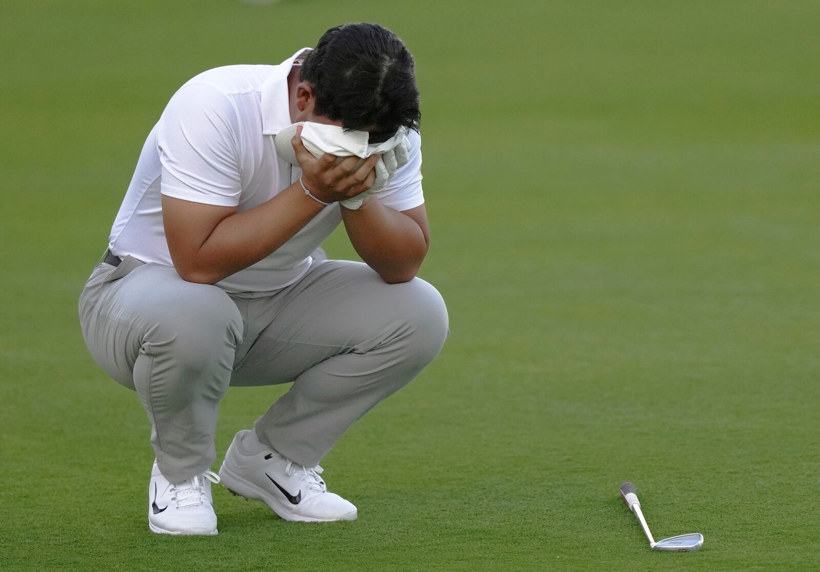 International team member Tom Kim of South Korea, reacts after a poor approach shot on the 16th hole during their fourth round foursomes match at the Presidents Cup golf tournament at Royal Montreal Golf Club Saturday, Sept. 28, 2024 in Montreal. (Nathan Denette/The Canadian Press via AP)