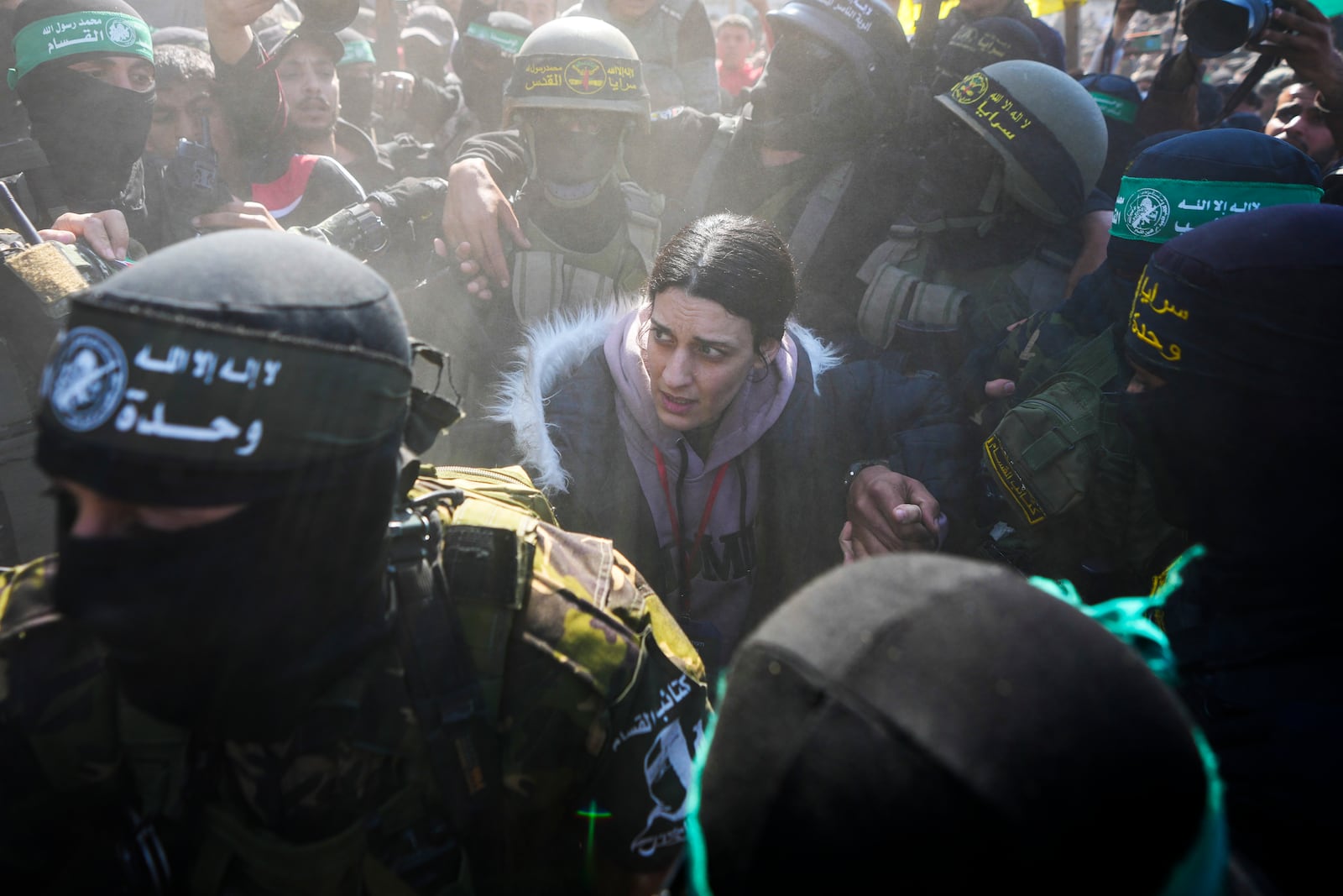 Israeli soldier Arbel Yehoud, 29, who has been held hostage by Hamas in Gaza since October 7, 2023, is escorted by Hamas and Islamic Jihad fighters as she is handed over to the Red Cross in Khan Younis, southern Gaza Strip, Thursday Jan. 30, 2025.(AP Photo/Abdel Kareem Hana)