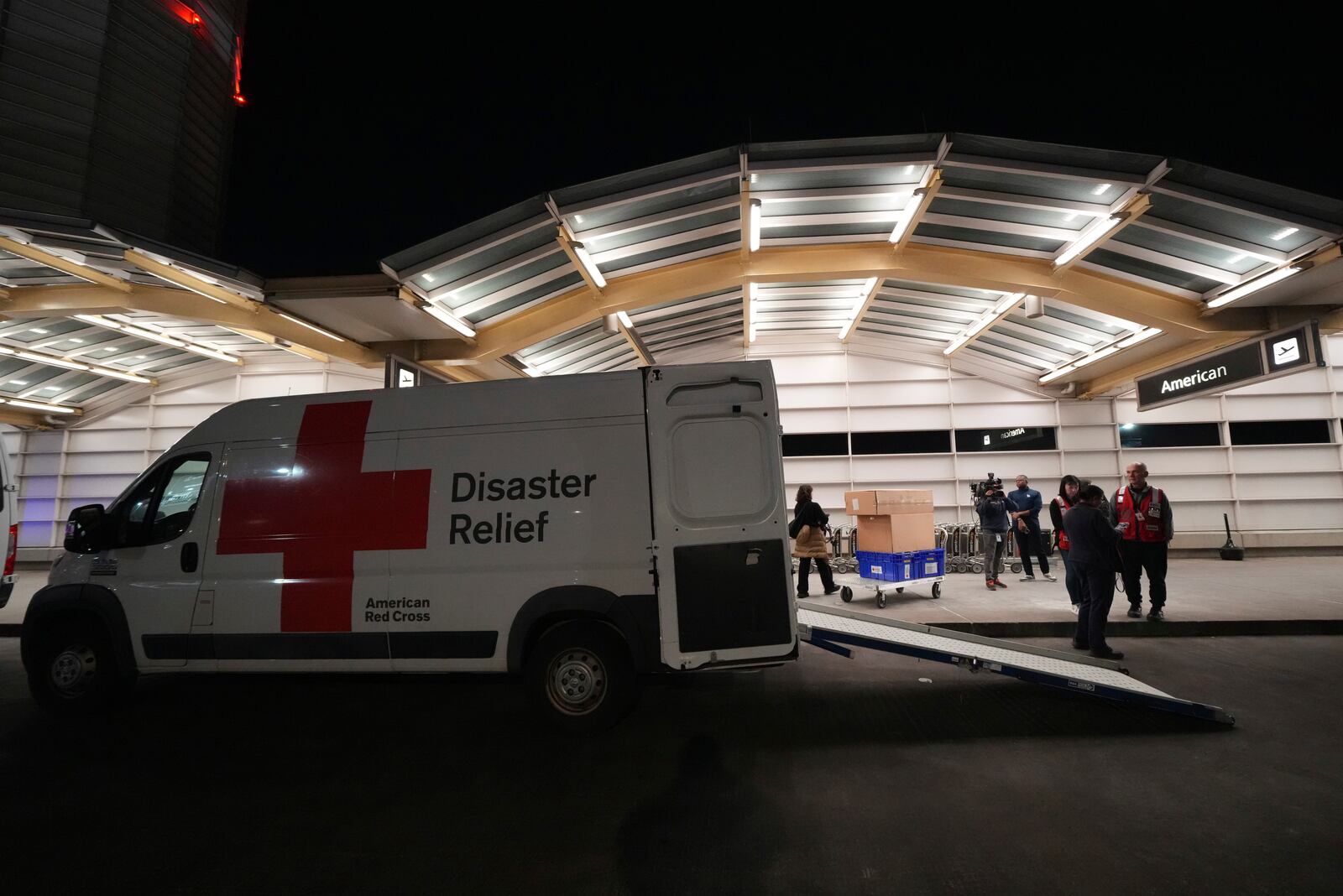 Workers from the American Red Cross arrive at Ronald Reagan Washington National Airport, Thursday, Jan. 30, 2025, in Arlington, Va. (AP Photo/Julio Cortez)