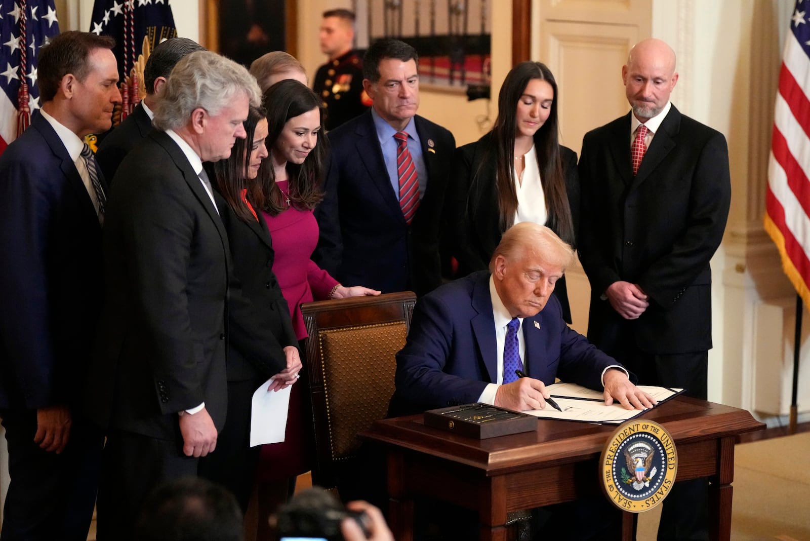 President Donald Trump signs the Laken Riley Act during an event in the East Room of the White House, Wednesday, Jan. 29, 2025, in Washington. (AP Photo/Alex Brandon)