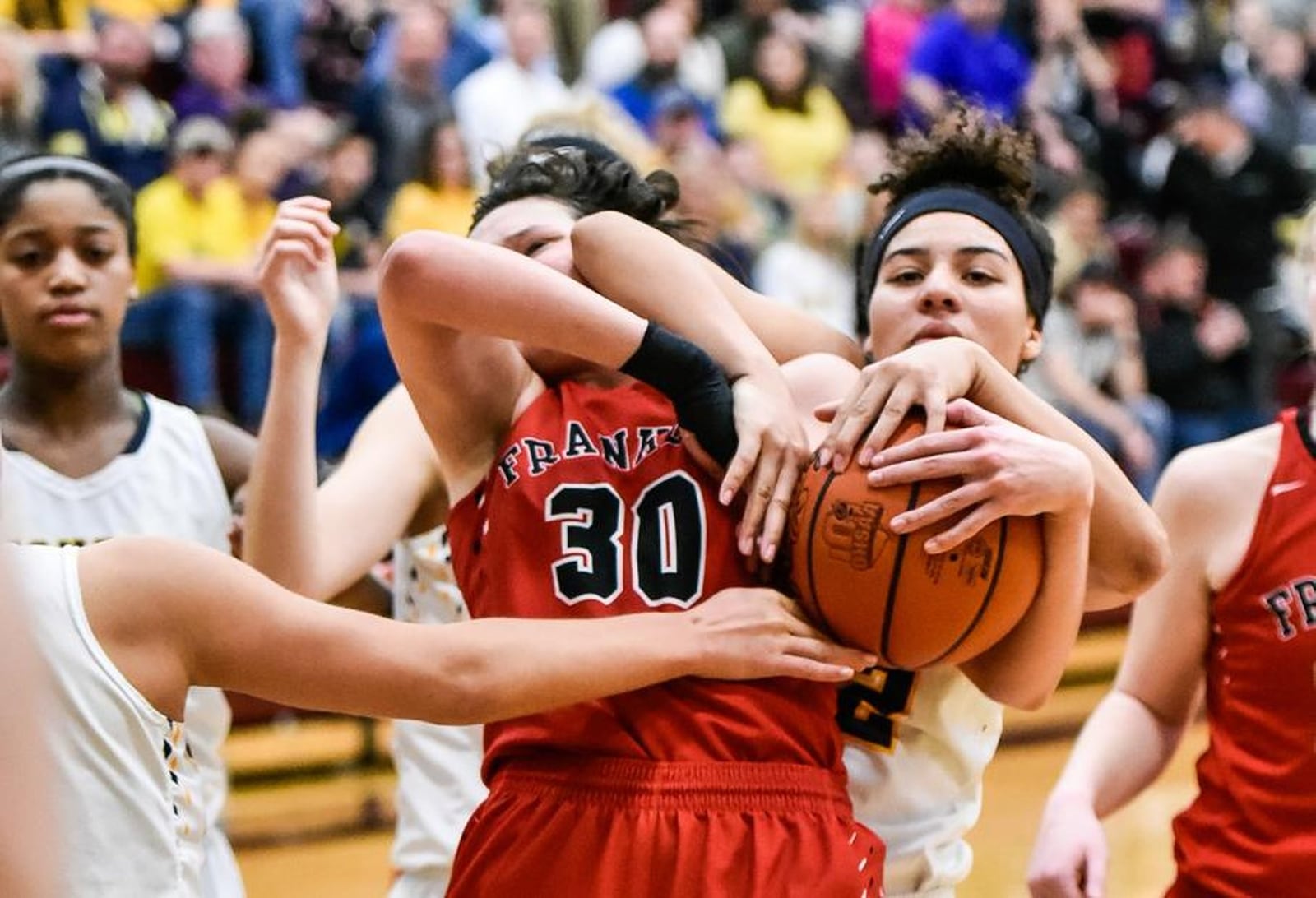 Franklin’s Layne Ferrell (30) and Monroe’s Jahsalyn Robinson battle for the ball during Monday night’s Division II sectional final at Lebanon. NICK GRAHAM/STAFF