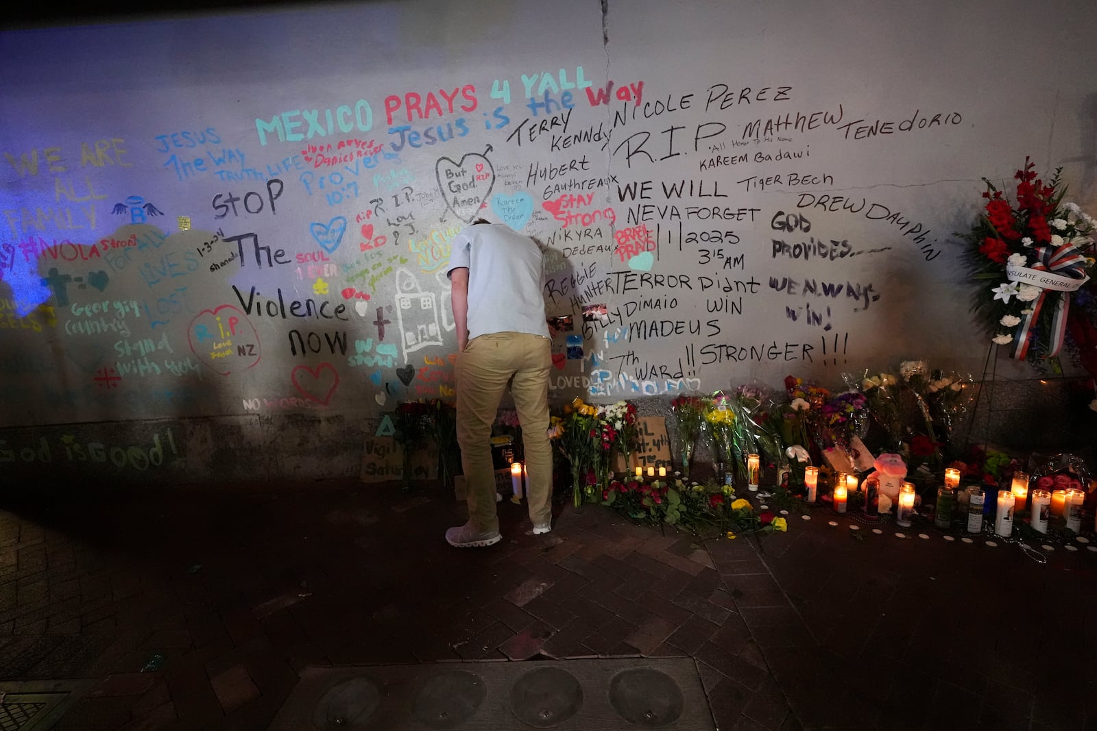 A friend of Kareem Badawi, a victim of the deadly truck attack on New Year's Day in New Orleans, pauses at a memorial for victims after attending his funeral, Friday, Jan. 3, 2025. (AP Photo/Gerald Herbert)