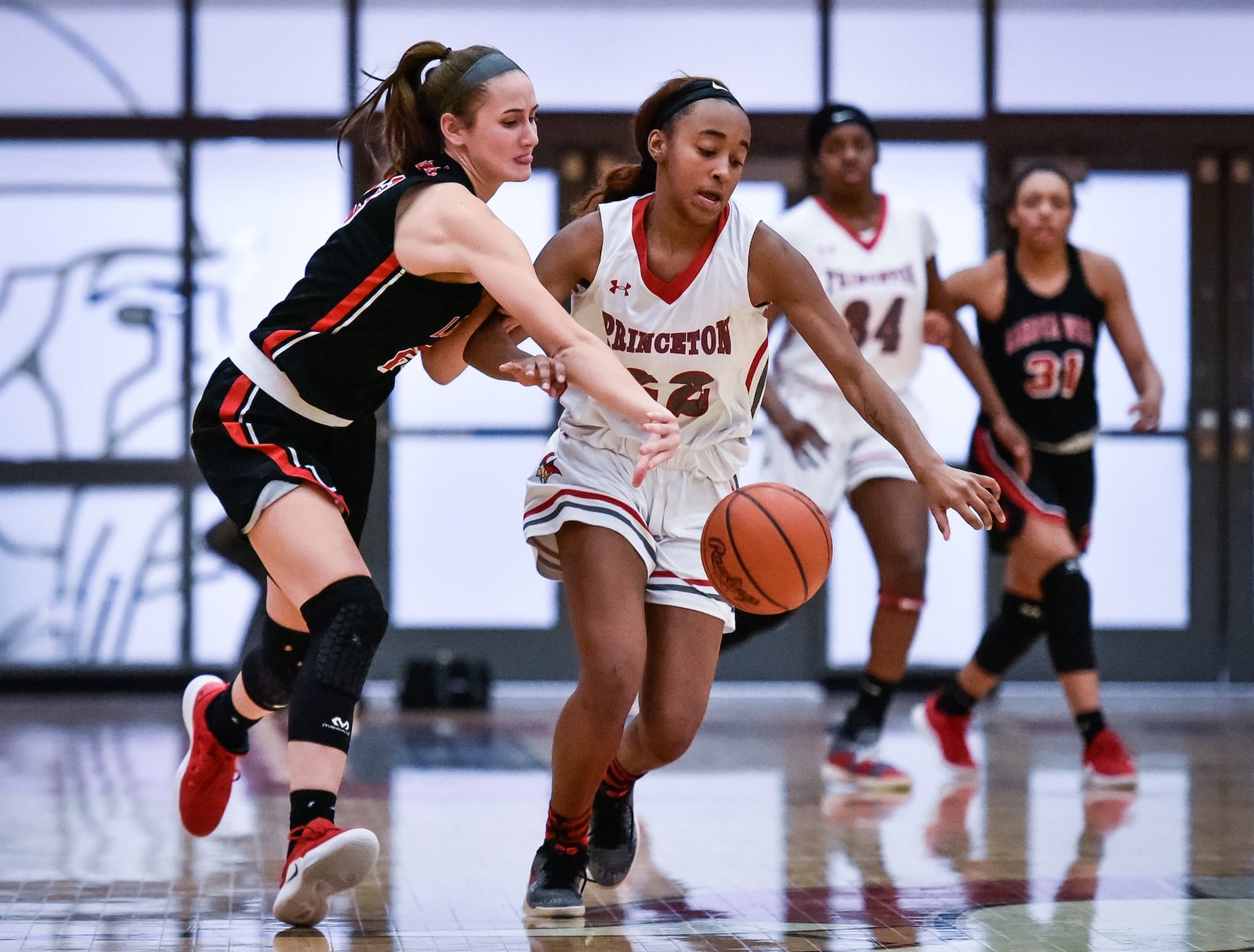 Lakota West’s Kailyn Dudukovich tries to keep the ball away from Princeton’s Jacquelyn Hinesmon on Wednesday night in Sharonville. West won 61-50 for coach Andy Fishman’s 400th career triumph. NICK GRAHAM/STAFF