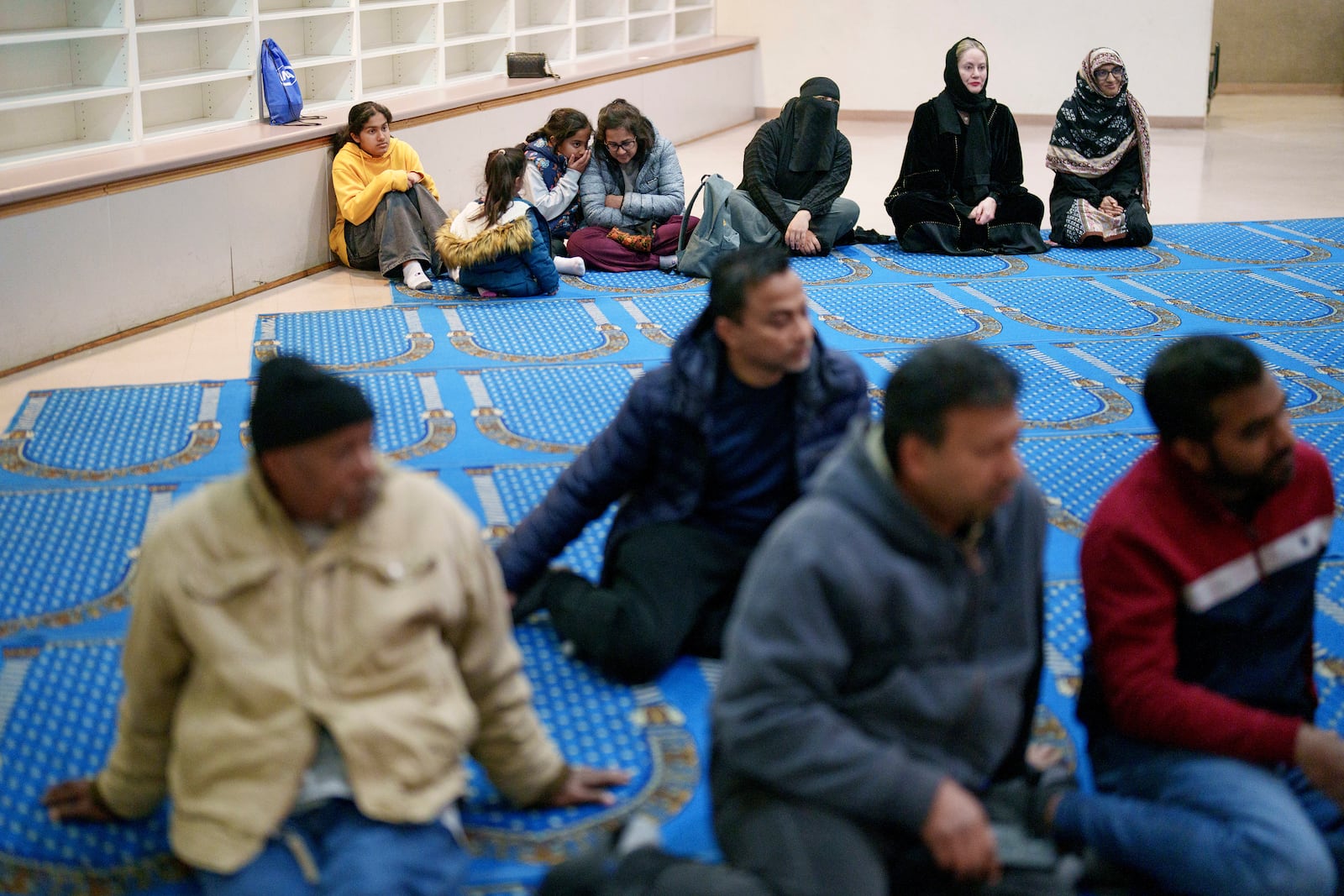 People listen during a community gathering for members of Masjid Al-Taqwa who lost their place of worship in the Eaton fire. They met at a school in Pasadena, California, Saturday, Feb. 15, 2025. (AP Photo/Eric Thayer)