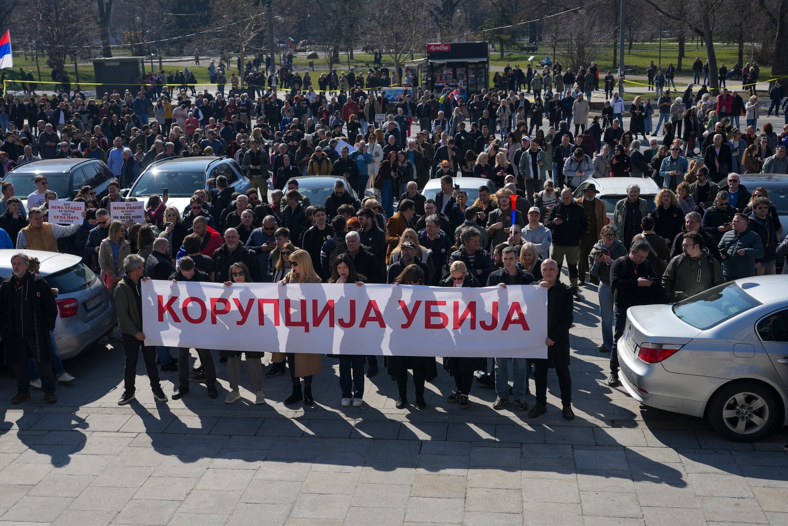 People hold a banner that reads: "Corruption kills" during a Serbia's parliament session in Belgrade, Serbia, Tuesday, March 4, 2025. (AP Photo/Darko Vojinovic)