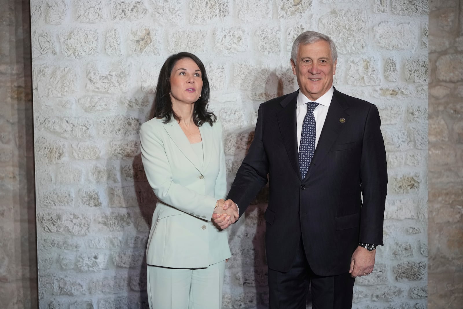 Italian Foreign Minister Antonio Tajani, greets German Foreign Minister Annalena Baerbock, as she arrives for a family photo at the G7 of foreign Ministers in Anagni, some 70 kilometers south-east of Rome, Monday, Nov. 25, 2024. (AP Photo/Alessandra Tarantino)