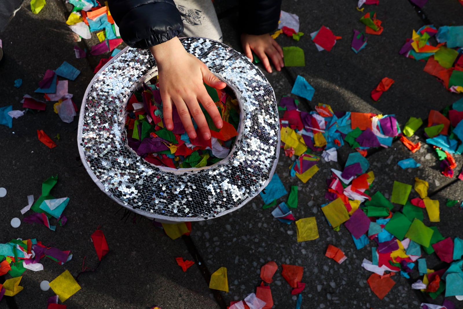 Kids collect confetti off the ground ahead of New Years Eve in Times Square, Sunday, Dec. 29, 2024, in New York. (AP Photo/Heather Khalifa)