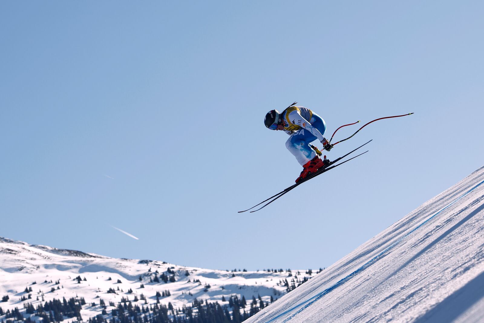 United States' Breezy Johnson is airborne during a women's downhill race, at the Alpine Ski World Championships, in Saalbach-Hinterglemm, Austria, Saturday, Feb. 8, 2025. (AP Photo/Gabriele Facciotti)