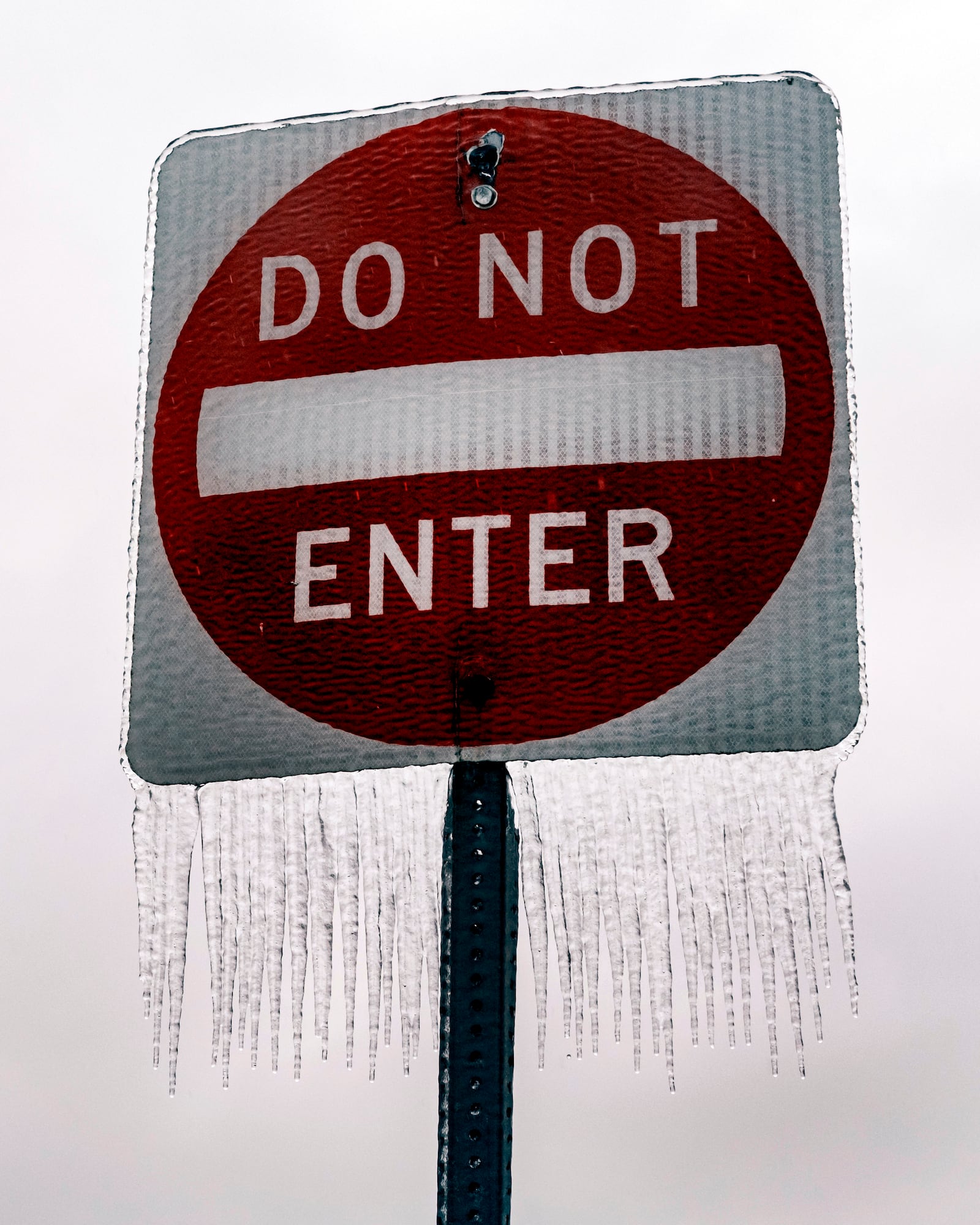 Ice accumulates on a road sign in North Liberty, Iowa on Saturday, Dec. 14, 2024. (Nick Rohlman/The Gazette via AP)