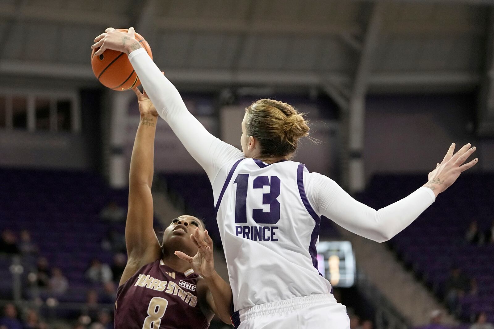 Texas State guard Ja'Mia Harris (8) has her shot blocked by TCU center Sedona Prince (13) in the first half of an NCAA college basketball game in Fort Worth, Texas, Wednesday, Nov. 13, 2024. (AP Photo/Tony Gutierrez)