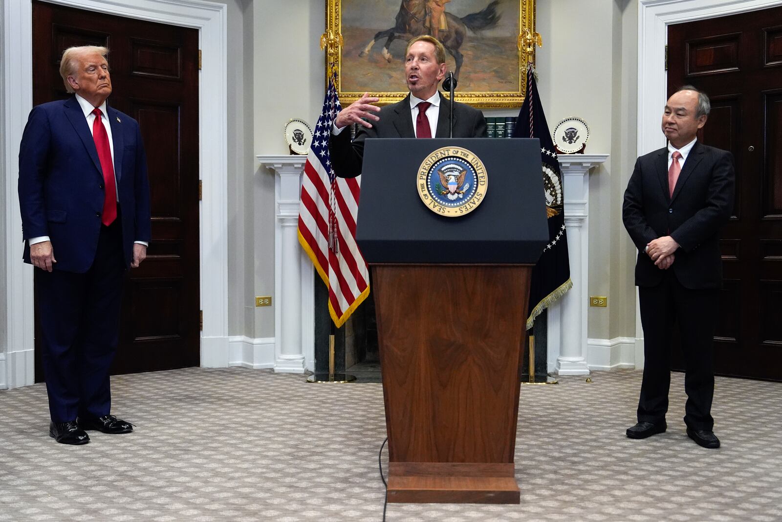 Larry Ellison, chairman of Oracle Corporation, center, speaks as President Donald Trump, left, and Masayoshi Son, SoftBank Group CEO, listen in the Roosevelt Room at the White House, Tuesday, Jan. 21, 2025, in Washington. (AP Photo/Julia Demaree Nikhinson)