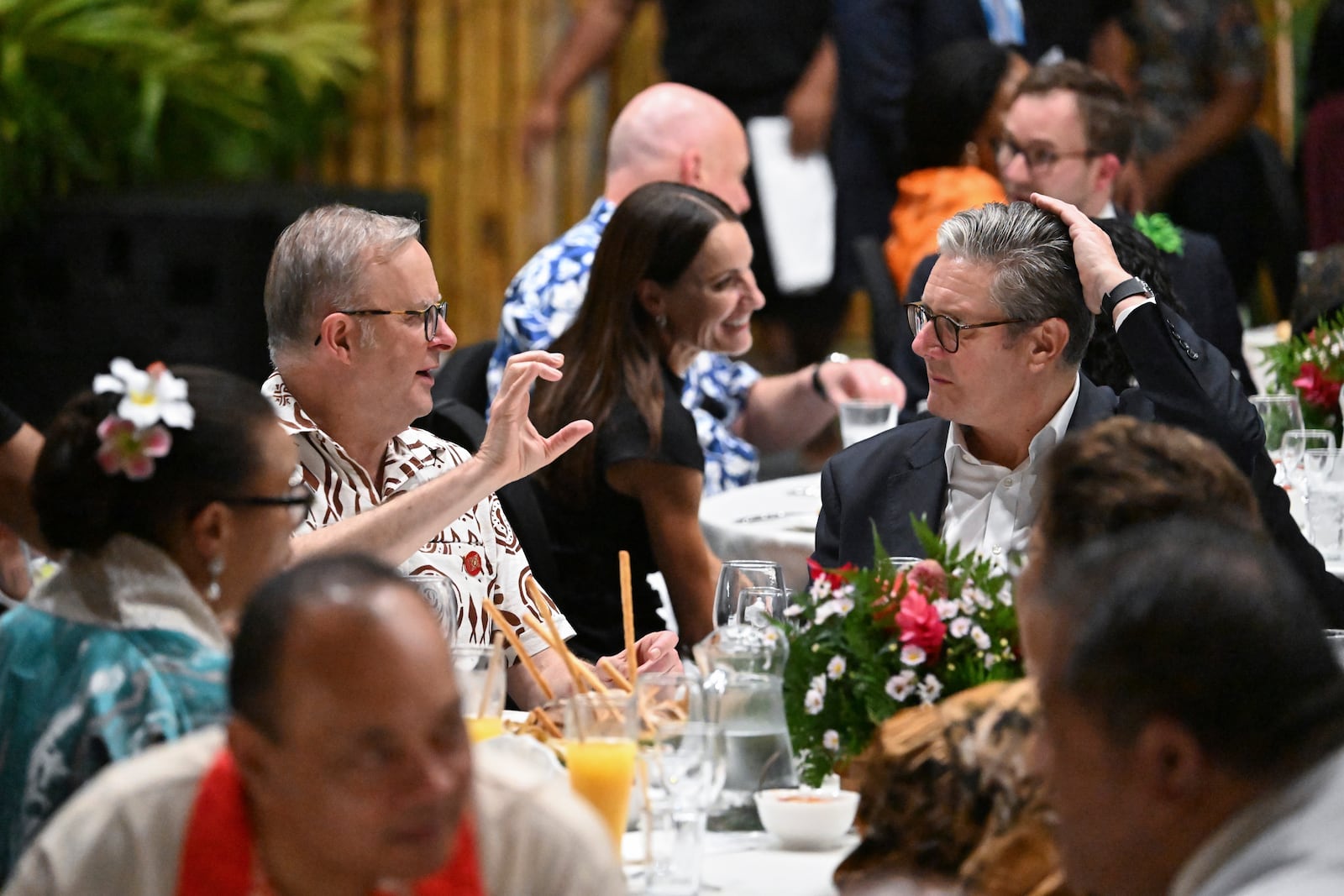 Australia's Prime Minister Anthony Albanese, left, talks with British Prime Minister Keir Starmer as they attend a State Banquet during the Commonwealth Heads of Government Meeting (CHOGM) in Apia, Samoa, on Thursday, Oct. 24, 2024. (William West/Pool Photo via AP)