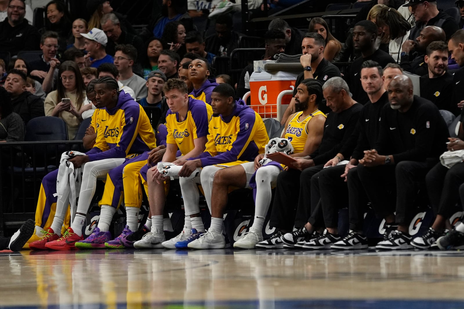 Los Angeles Lakers players sit on the bench during the final minutes of an NBA basketball game against the Minnesota Timberwolves, Friday, Dec. 13, 2024, in Minneapolis. (AP Photo/Abbie Parr)