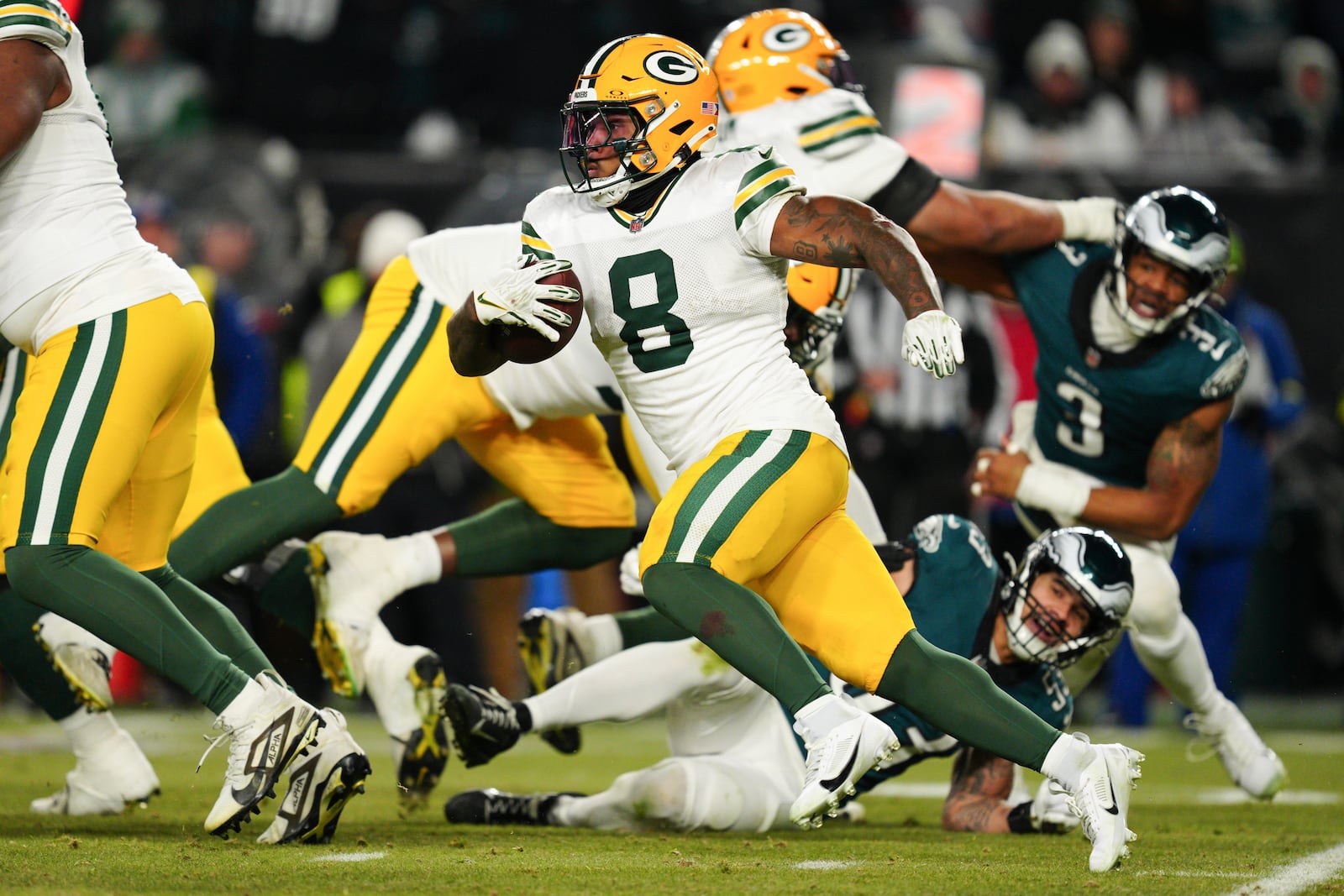 Green Bay Packers running back Josh Jacobs (8) runs with the ball during the second half of an NFL wild-card playoff football game against the Philadelphia Eagles on Sunday, Jan. 12, 2025, in Philadelphia. (AP Photo/Derik Hamilton)