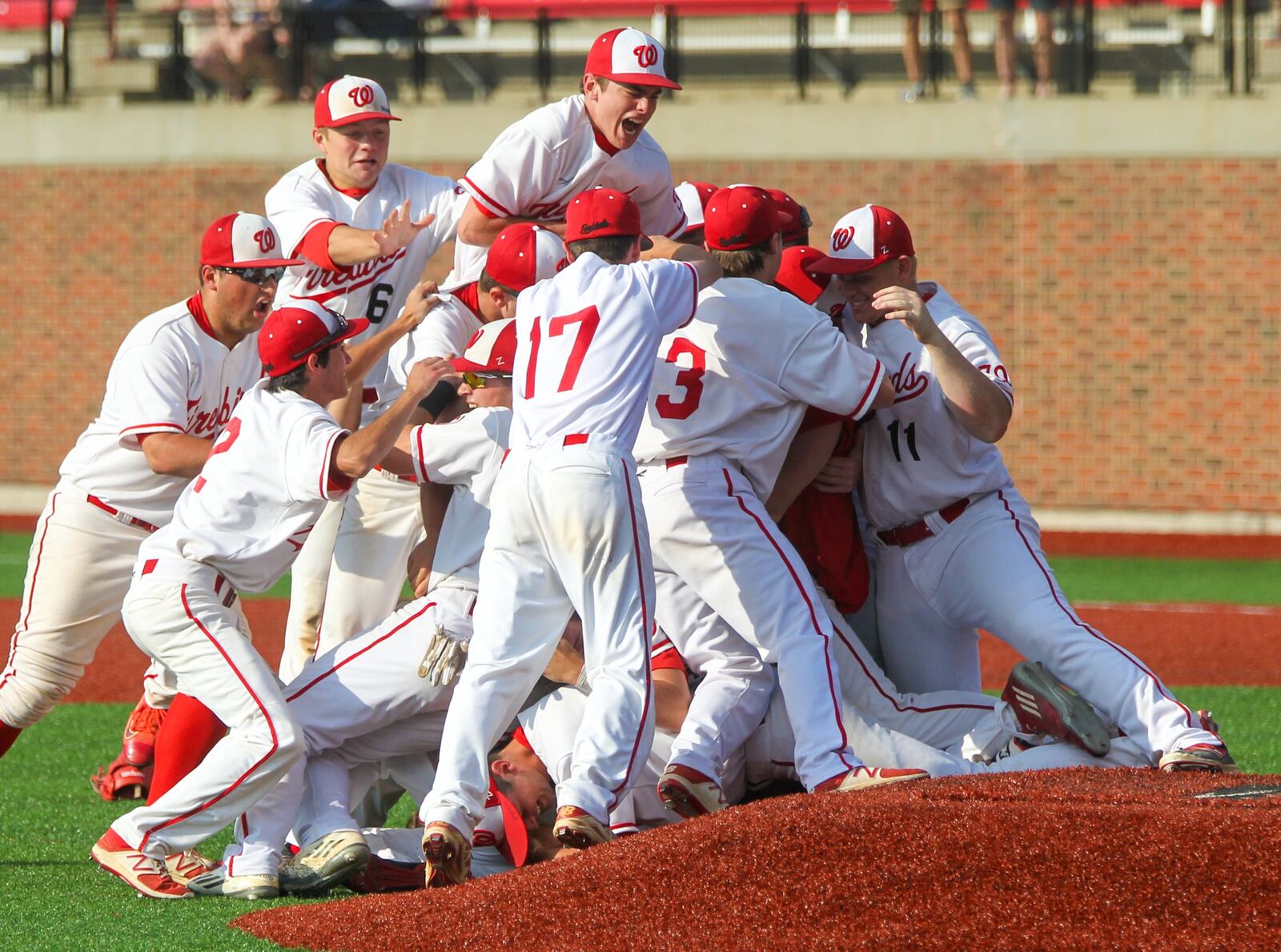 Lakota West’s players celebrate on the field Friday after beating St. Xavier 2-1 to capture a Division I regional championship at the University of Cincinnati’s Marge Schott Stadium. GREG LYNCH/STAFF