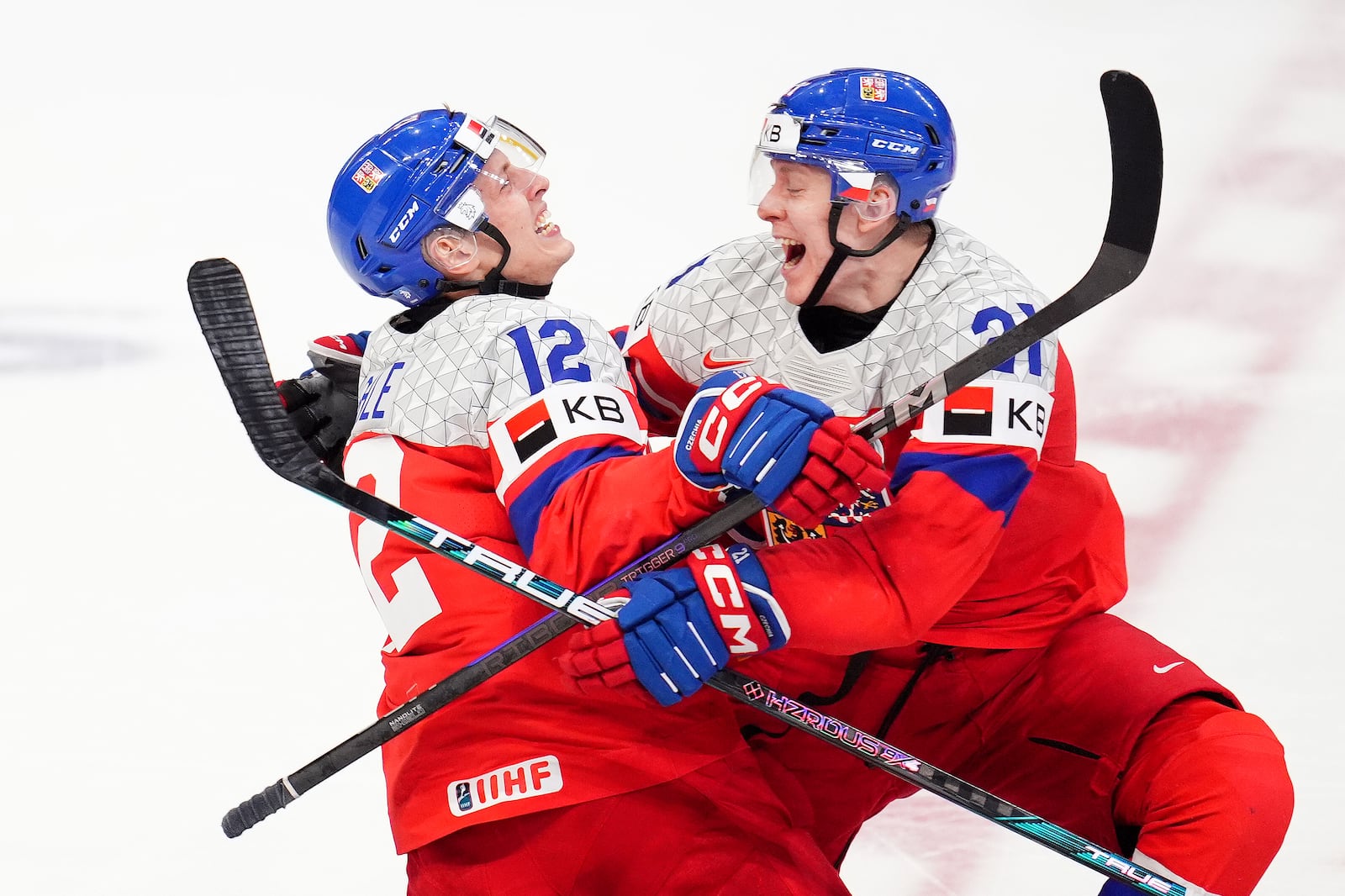 Czechia forward Eduard Sale (12) celebrates his game-winning goal with teammate Czechia forward Jakub Stancl (21) as they win the World Junior hockey championship bronze medal penalty shot shootout against Sweden, in Ottawa, Sunday, Jan. 5, 2025. (Sean Kilpatrick/The Canadian Press via AP)