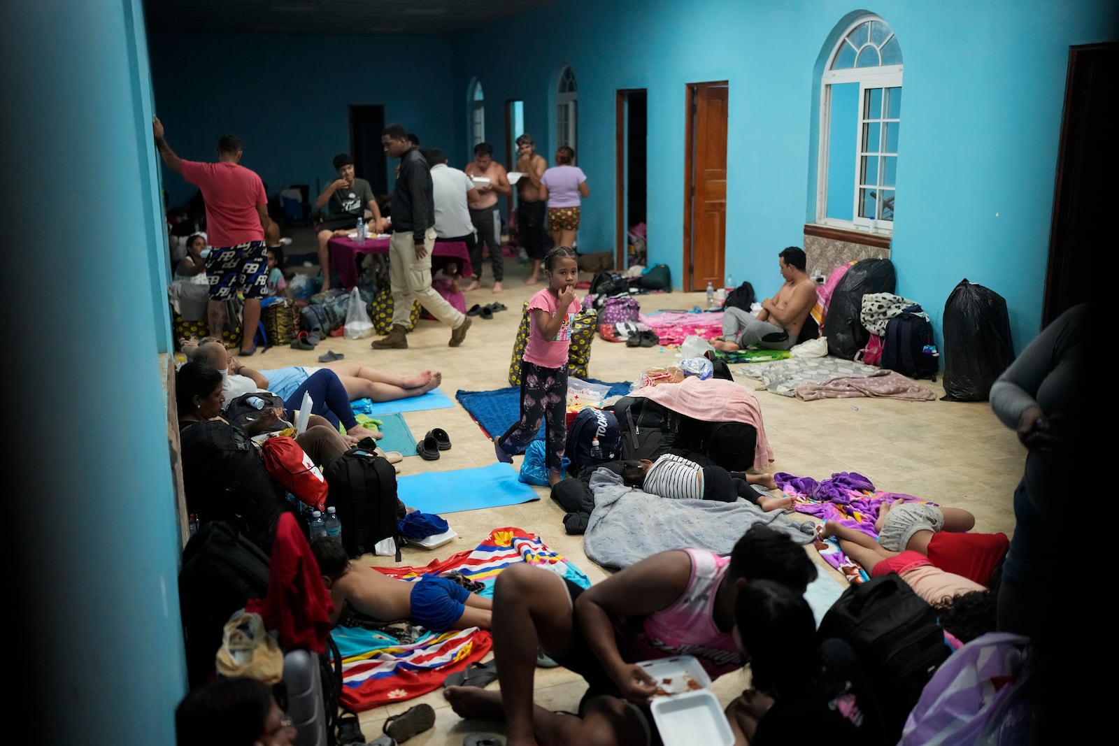 Migrants spend the night in a shelter in Palenque, Panama, Wednesday, Feb. 26, 2025. The migrants are returning from southern Mexico after giving up on reaching the U.S., a reverse flow triggered by the Trump administration's immigration crackdown. (AP Photo/Matias Delacroix)