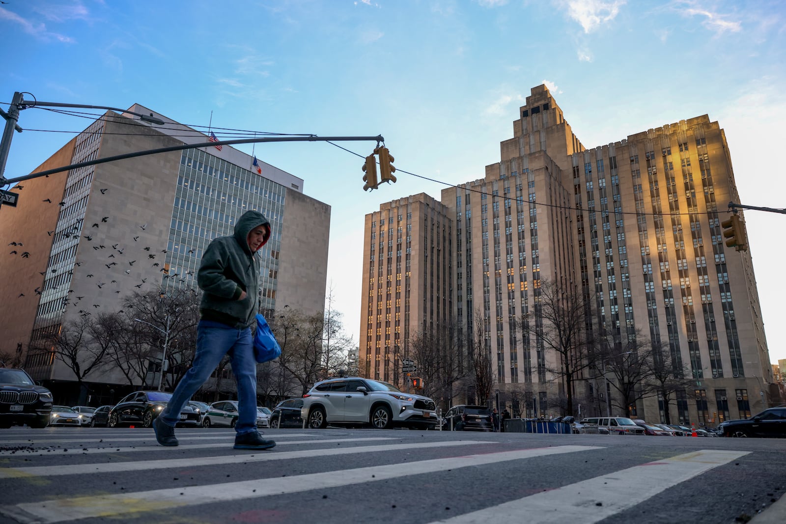 A man crosses the street outside Manhattan criminal court before the start of the sentencing in President-elect Donald Trump's hush money case, Friday, Jan. 10, 2025, in New York. (AP Photo/Yuki Iwamura)