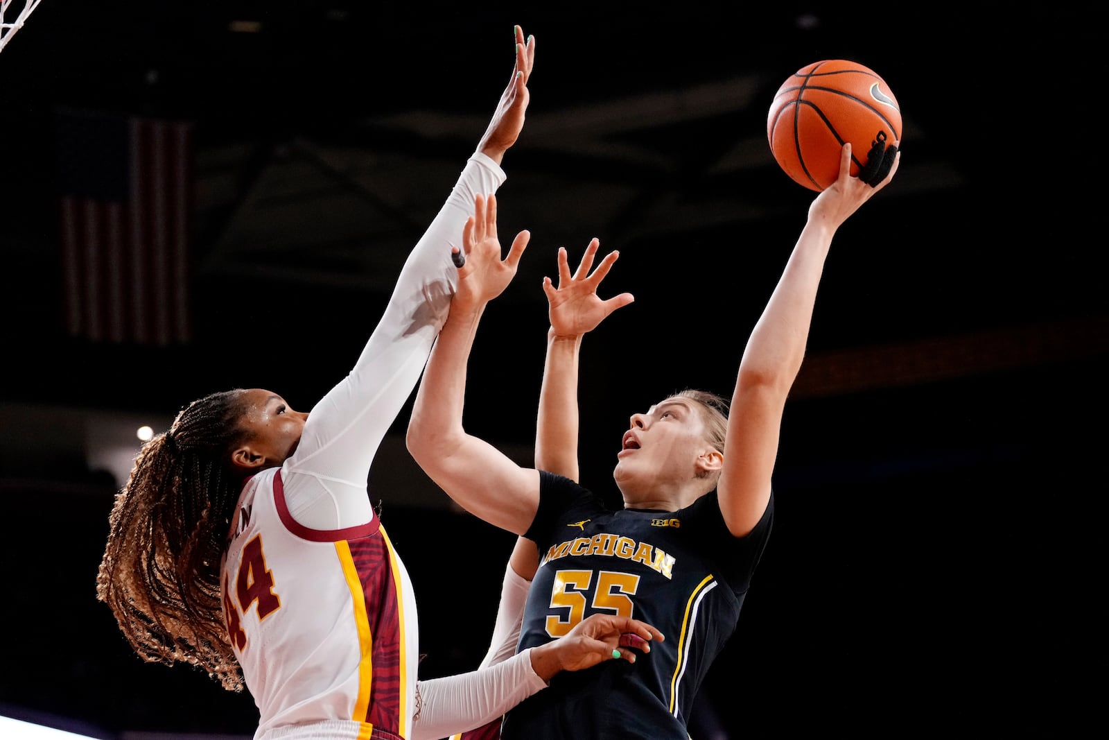 Michigan center Yulia Grabovskaia, right, shoots as Southern California forward Kiki Iriafen defends during the first half of an NCAA college basketball game, Sunday, Dec. 29, 2024, in Los Angeles. (AP Photo/Mark J. Terrill)