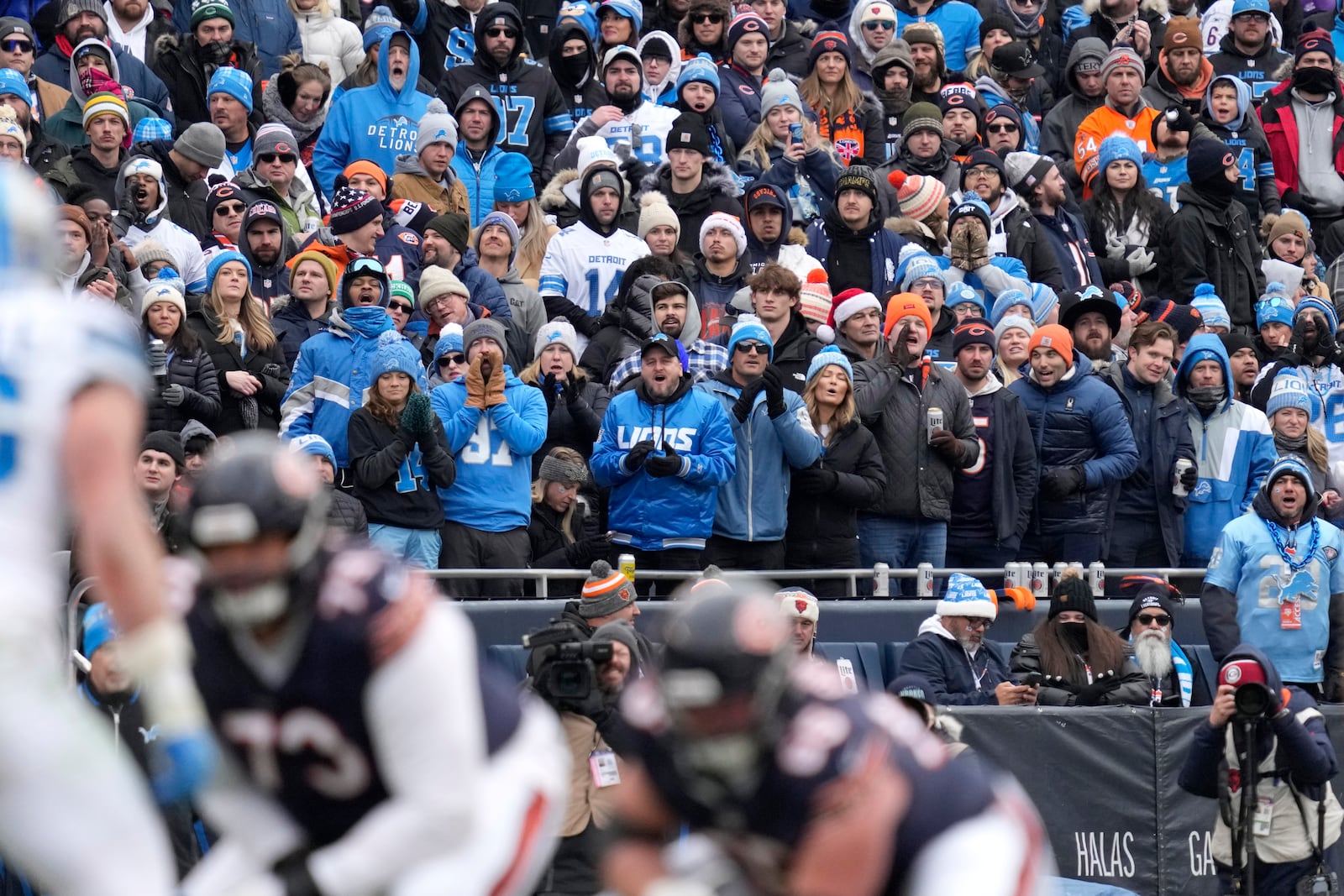 Detroit Lions fans watch their team during the first half of an NFL football game against the Chicago Bears on Sunday, Dec. 22, 2024, in Chicago. (AP Photo/Nam Y. Huh)