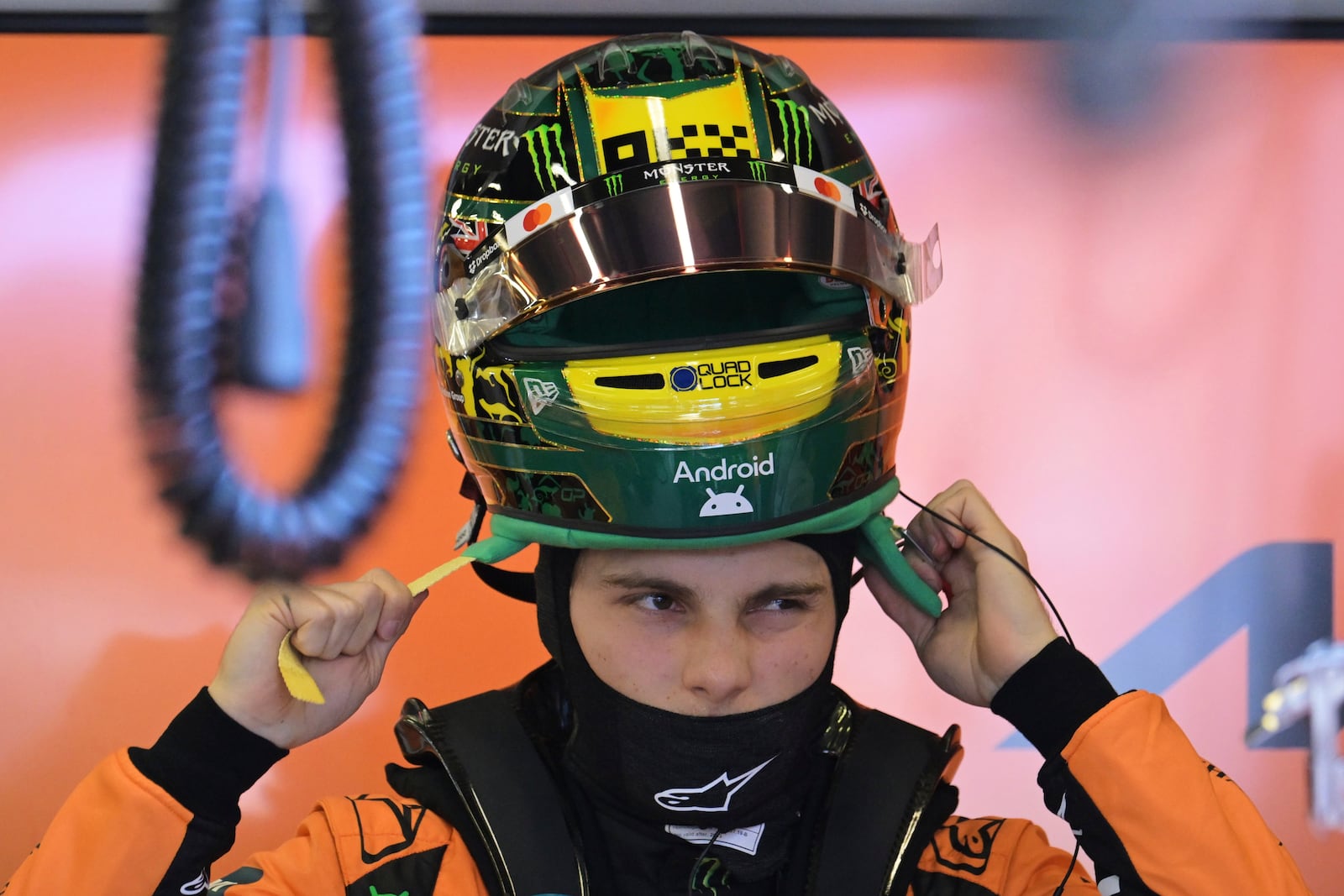 McLaren driver Oscar Piastri of Australia puts his helmet on during qualifying at the Australian Formula One Grand Prix at Albert Park, in Melbourne, Australia, Saturday, March 15, 2025. (Tracey Nearmy/Pool Photo via AP)