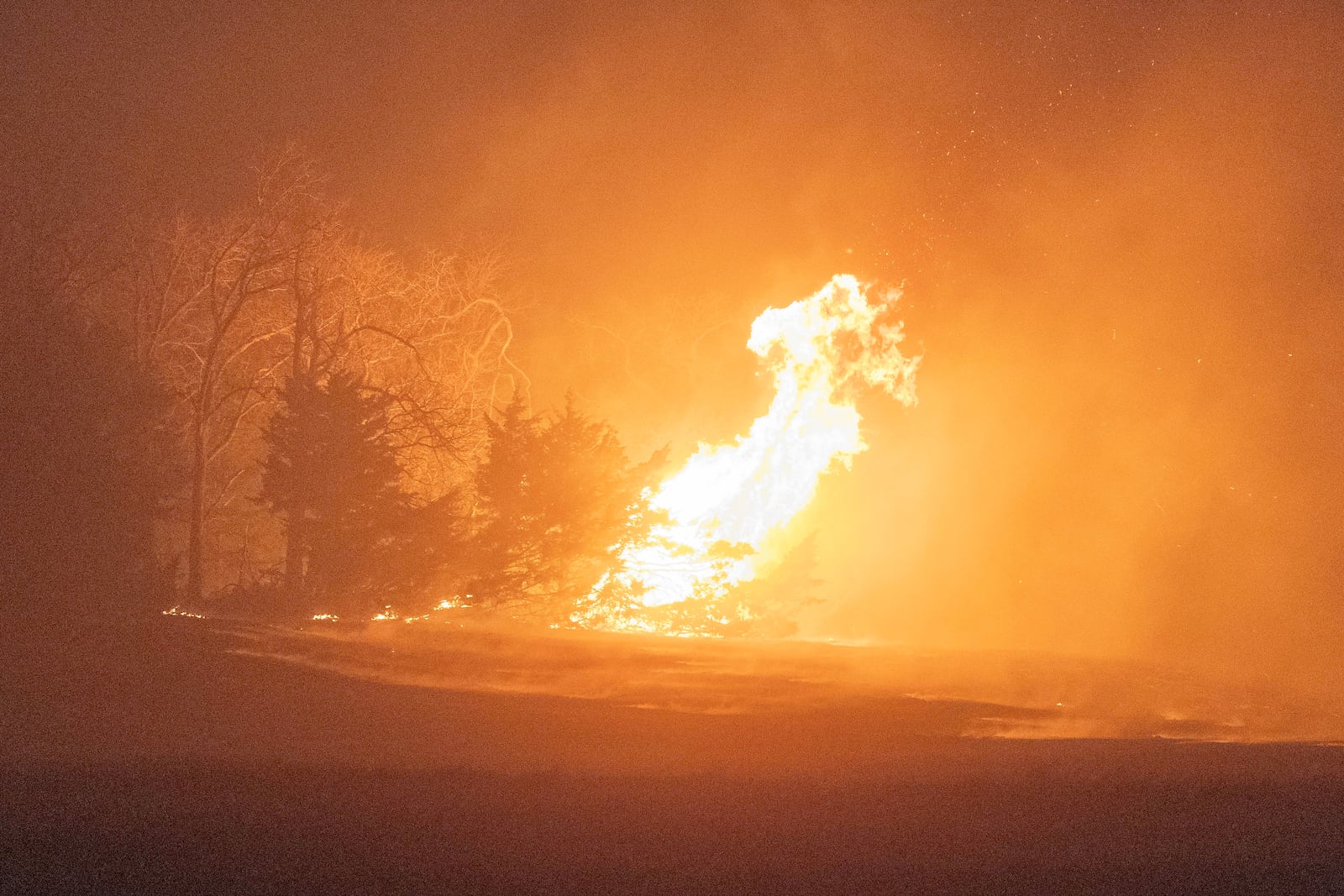 A wildfire burns at night on Friday, March 14, 2025, south of Langston, Okla. (AP Photo/Alonzo Adams)