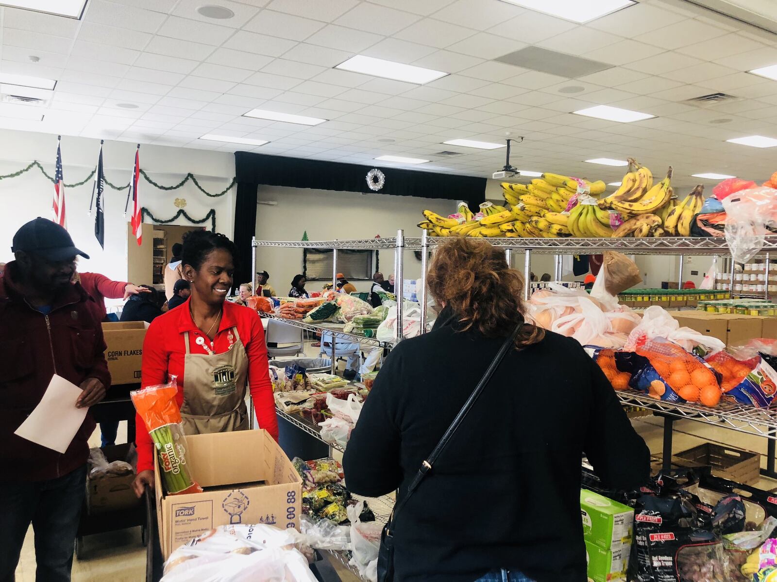 Volunteers help veterans choose food products at the Dayton VA Food Pantry. Tuesday was the third time the VA has hosted the program. KARA DRISCOLL/STAFF