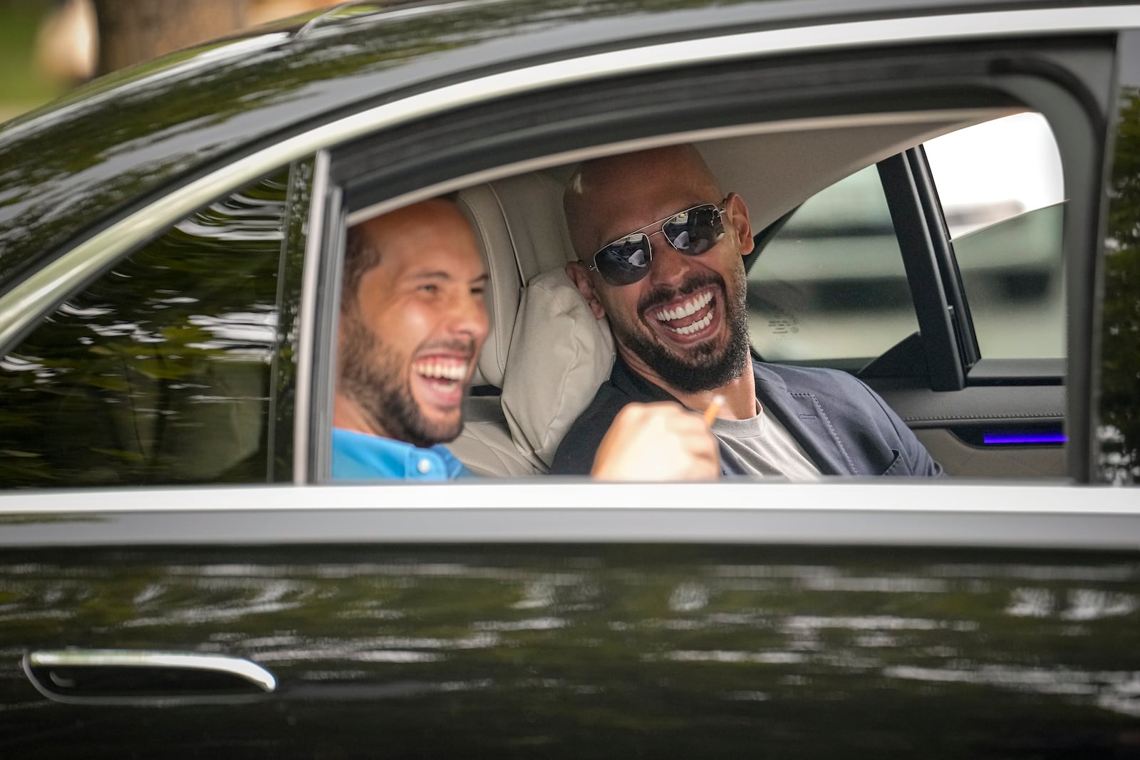 FILE - Andrew Tate, right, and his brother Tristan laugh as they leave the Bucharest Tribunal in Bucharest, Romania, May 8, 2024. (AP Photo/Vadim Ghirda, File)