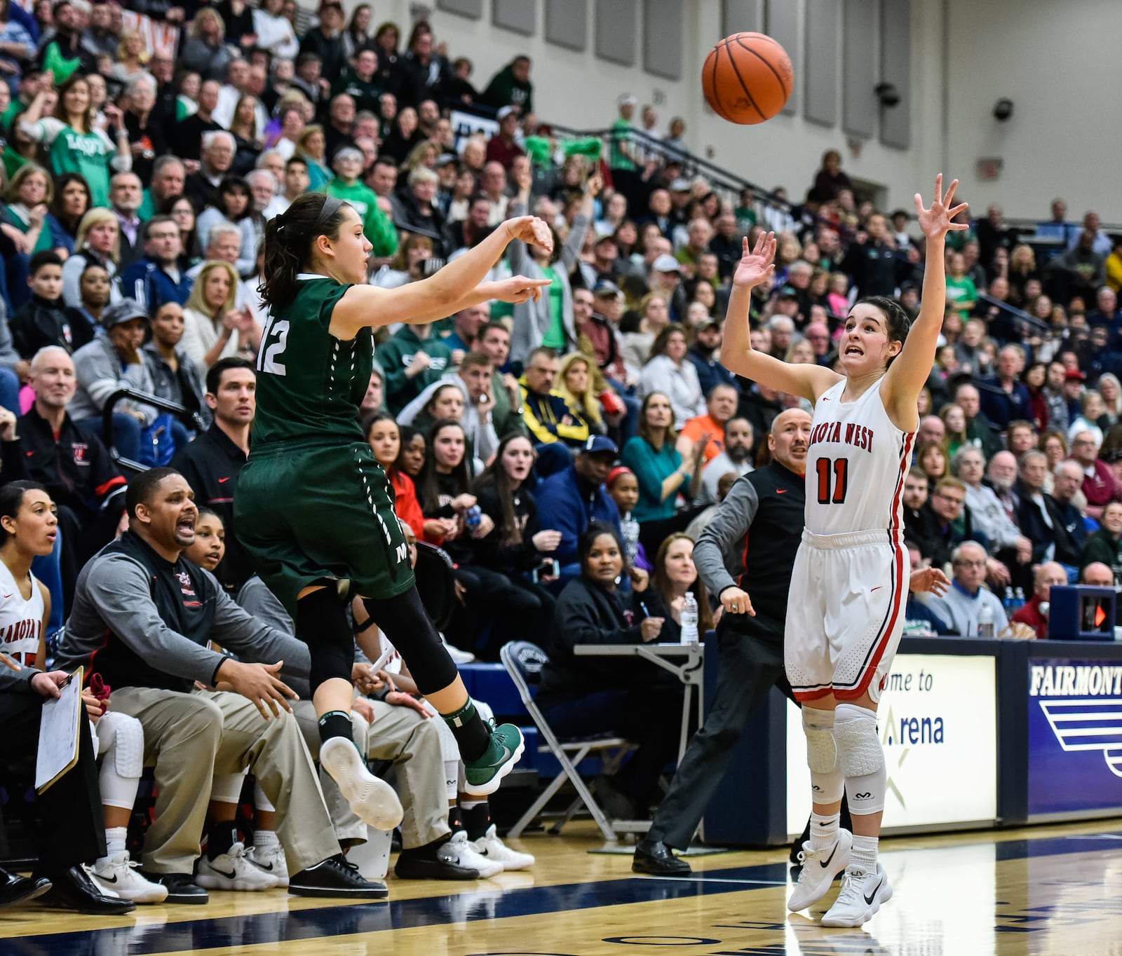 Mason’s Megan Wagner makes a pass over Madisyn Oxley of Lakota West on Saturday night during a Division I regional final at Fairmont’s Trent Arena. NICK GRAHAM/STAFF